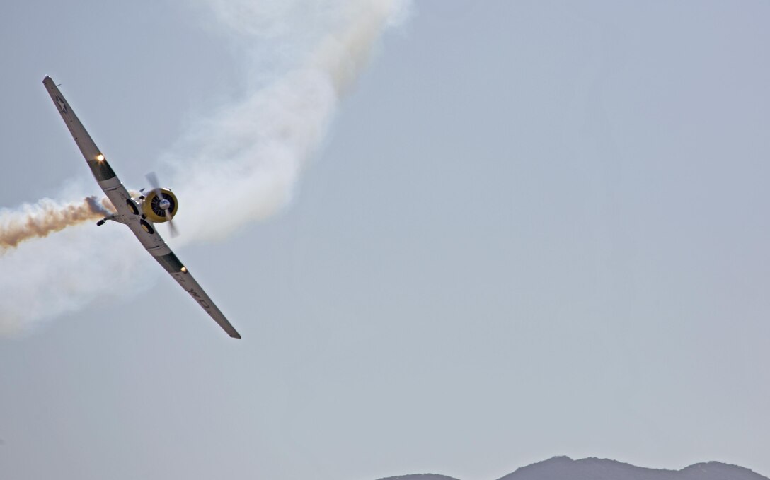 A North American AT-6 Texan “Wardog” performs aerobatic maneuvers for crowds aboard Marine Corps Air Station Miramar, Calif., Oct. 2. The Wardog performed a routine during the 2015 MCAS Miramar Air Show. (U.S. Marine Corps photo by Sgt. Uriel Avendano/Released)