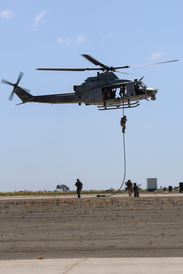 Marines with 1st Marine Division fast rope out of a UH-1Y Huey while demonstrating Marine Air Ground Task Force operations during the 2015 MCAS Miramar Air Show aboard Marine Corps Air Station Miramar, Calif., Oct. 2. This year's air show honored veterans and their families. (U.S. Marine Corps photo by Cpl. Alissa P. Schuning/Released)