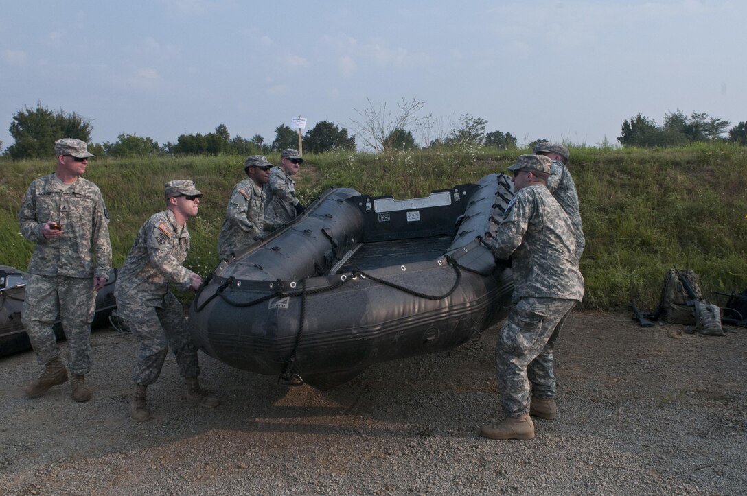U.S. Army Reserve combat engineers with the 383rd Engineer Company (Mobility Augmentation), Jonesboro, Ark., lift a Zodiac boat for a timed carry while competing in Sapper Stakes 2015 at Fort Chaffee, Ark., Aug. 31. (U.S. Army photo by Staff Sgt. Debralee Best)