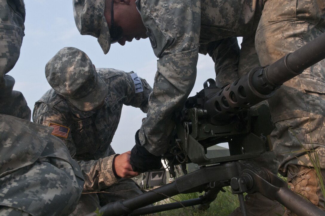 Wisconson National Guard combat engineers with the 273rd Engineer Company (Sapper), remove an M2 .50-caliber machine gun from its tripod for a relay during Sapper Stakes 2015 at Fort Chaffee, Ark., Aug. 31. (U.S. Army photo by Staff Sgt. Debralee Best)