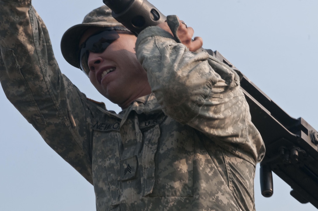 U.S. Army Reserve Sgt. Andrew Newlon, combat engineer, 688th Engineer Company (Mobility Augmentation) out of Harrison, Ark., lifts an M2 .50-caliber machine gun for a relay during Sapper Stakes 2015 at Fort Chaffee, Ark., Aug. 31. (U.S. Army photo by Staff Sgt. Debralee Best)