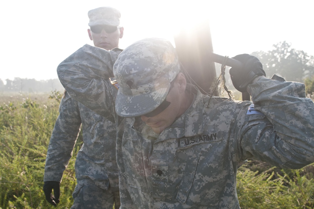 U.S. Army Reserve Spc. Randy Lene, combat engineer, 309th Engineer Company (Mobility Augmentation), hauls a picket pounder to the next picket while emplacing a hasty frat fence during Sapper Stakes 2015 at Fort Chaffee, Ark., Sept. 1. Hasty frat fences are usually used to cordon off minefields. (U.S. Army photo by Staff Sgt. Debralee Best)