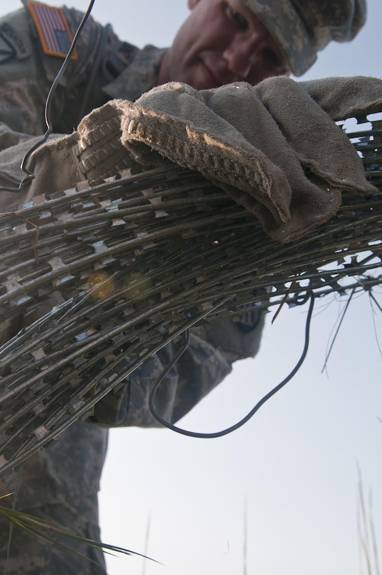 U.S. Army Reserve and National Guard Sapper Stakes 2015 competitors emplaced a hasty frat fence using concertina wire and pickets as part of the competition at Fort Chaffee, Ark., Sept. 1. (U.S. Army photo by Staff Sgt. Debralee Best)
