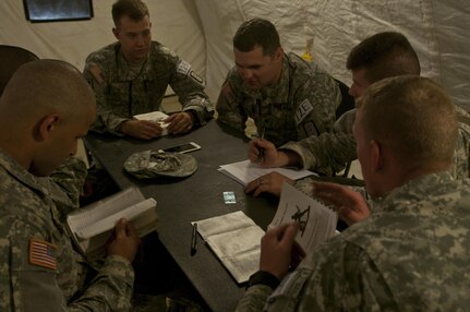 U.S. Army Reserve Soldiers from the 688th Engineer Company (Mobility Augmentation) out of Harrison, Ark., discusses test questions during the knowledge verification portion of Sapper Stakes 2015 at Fort Chaffee, Ark., Aug. 30. (U.S. Army photo by Staff Sgt. Debralee Best)