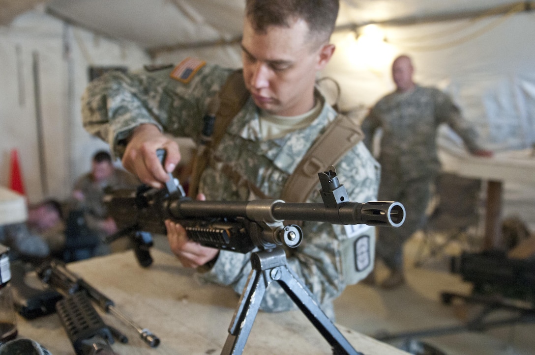 U.S. Army Reserve Sgt. Andrew Newlon, combat engineer, 688th Engineer Company (Mobility Augmentation) out of Harrison, Ark., disassembles a M240B machine gun during a weapons jumble at Sapper Stakes 2015 in Fort Chaffee, Ark., Aug. 30. Each team member was required to disassemble, reassemble and perform a weapons check on a weapon system. (U.S. Army photo by Staff Sgt. Debralee Best)