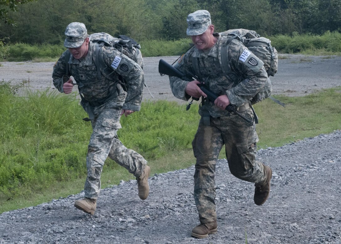 U.S. Army Reserve Spcs. Todd Brandell (left) and Trevore Klein, both with the 309th Engineer Company (Mobility Augmentation) out of Brainerd, Minn., finish the 4.1 mile ruck march during the nonstandard Army physical fitness test of Sapper Stakes 2015 at Fort Chaffee, Ark., Aug. 30. (U.S. Army photo by Staff Sgt. Debralee Best)