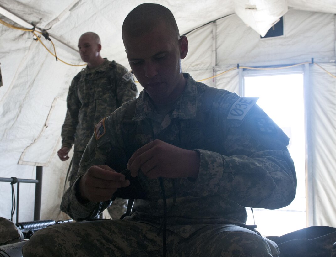 Spc. Timothy Mayer, combat engineer, 382nd Engineer Company (Sapper) out of Harrisburg, Pa., ties a knot during Sapper Stakes 2015, Aug. 30 at Fort Chaffee, Ark. Competing teams were scored on their ability to correctly tie six of eight knots. (U.S. Army photo by Staff Sgt. Debralee Best)