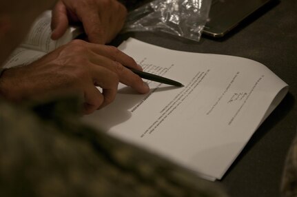 Soldiers read test questions during the knowledge verification portion of Sapper Stakes 2015 at Fort Chaffee, Ark., Aug. 30. (U.S. Army photo by Staff Sgt. Debralee Best)