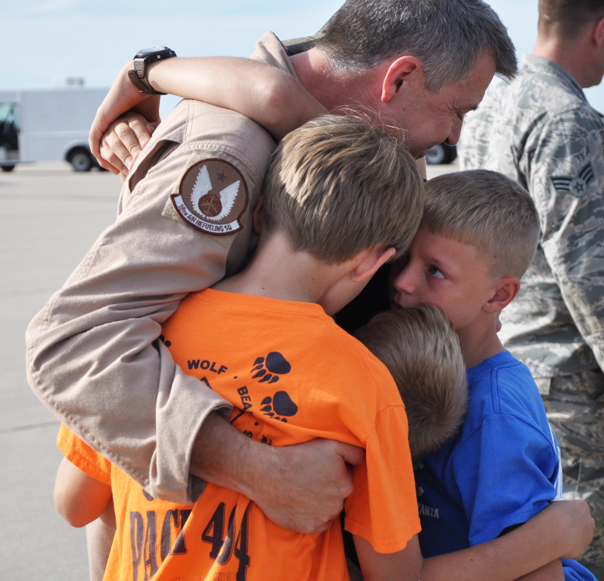 Senior Master Sgt. John Wallman, 18th Air Refueling Squadron boom operator, embraces his family after stepping of a KC-135 Stratotanker, Oct. 4, 2015, at McConnell Air Force Base, Kan. Wallman and 19 other Reservists returned after a deployment to Southwest Asia. (U.S. Air Force photo by Tech. Sgt. Abigail Klein)