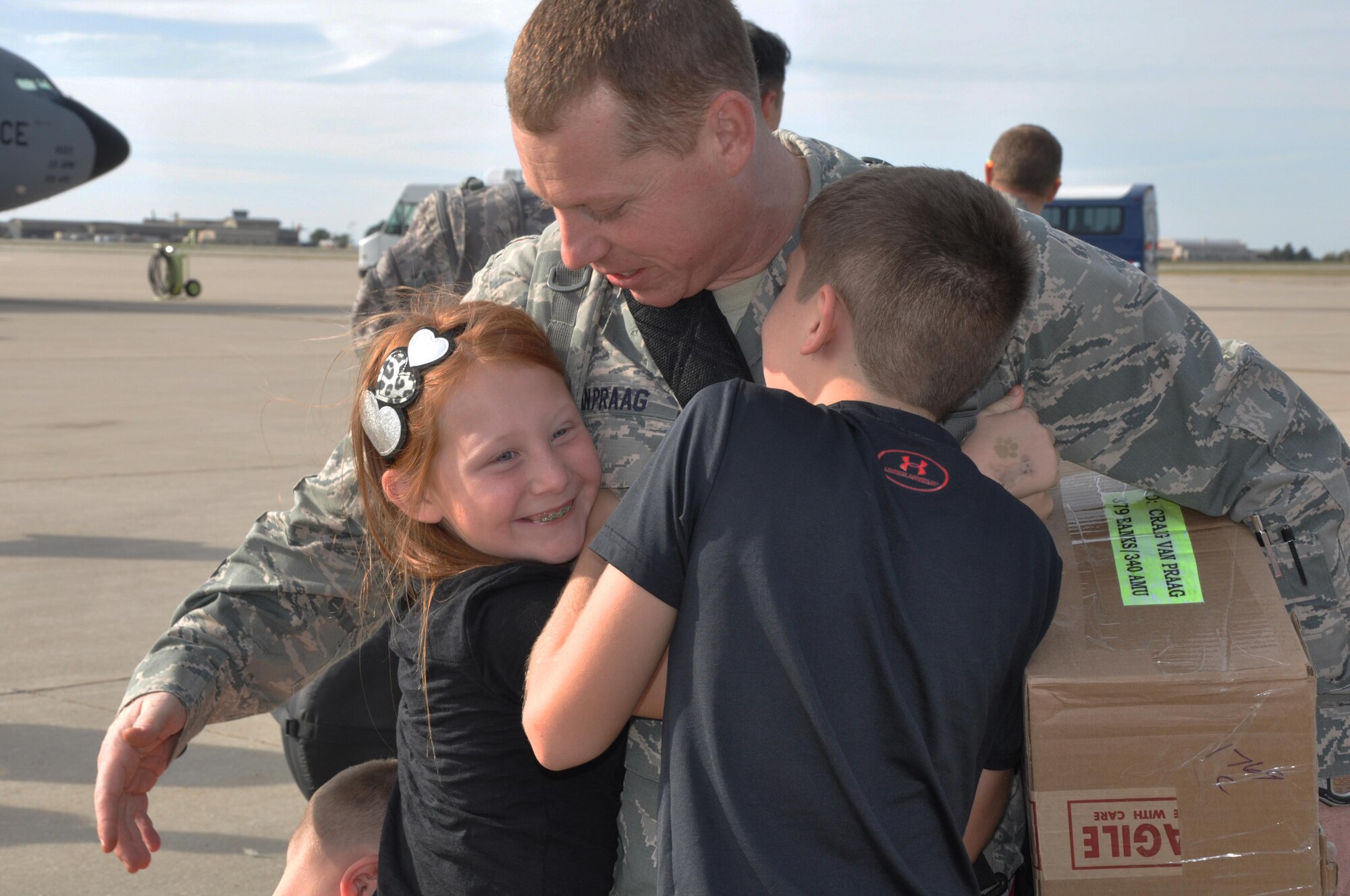 Capt. Craig Van Praag, 931st Aircraft Maintenance Squadron OIC, greets his children after returning from a deployment to Southwest Asia, Oct. 4, 2015, at McConnell Air Force Base, Kan. Van Praag returned along with 19 other Reservists. (U.S. Air Force photo by Tech. Sgt. Abigail Klein)