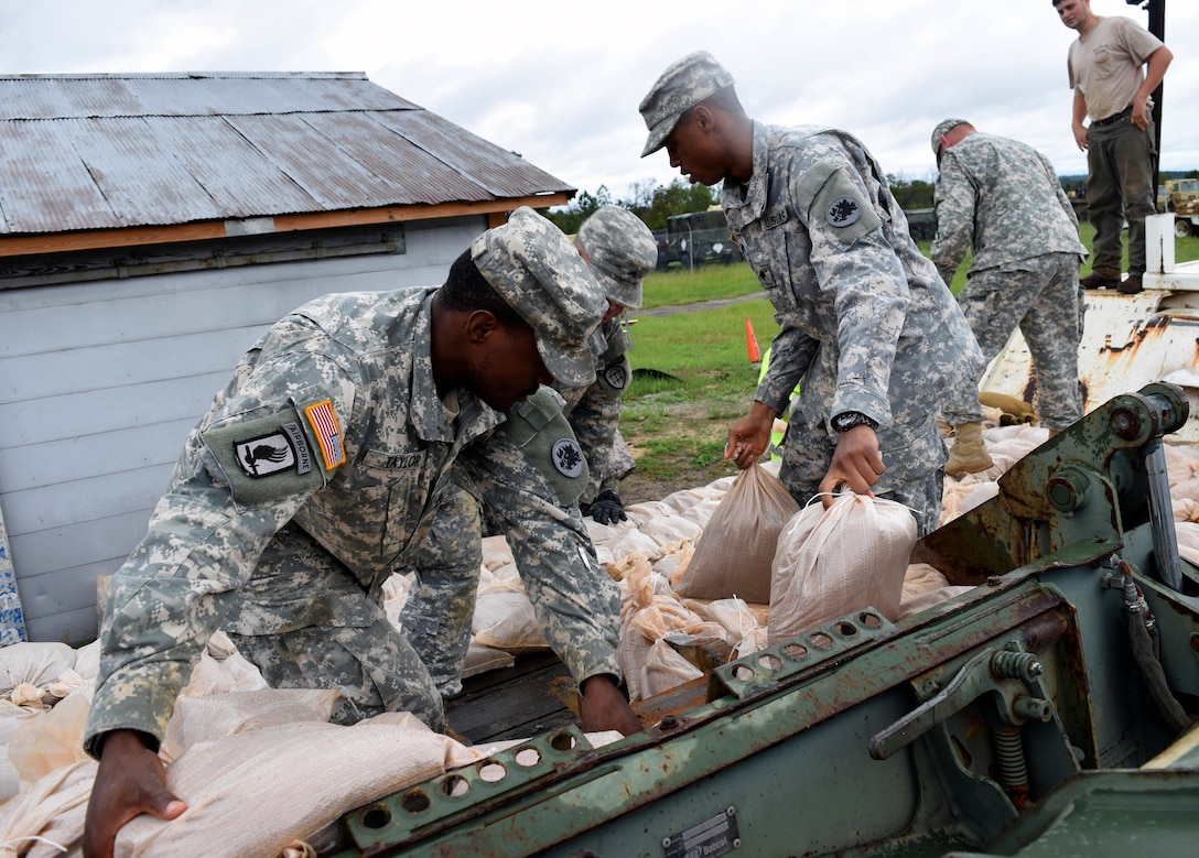 Soldiers load sandbags with the assistance of Georgia State Defense Force volunteers in Augusta, Georgia, Oct. 4, 2015. The soldiers are engineers assigned to the Georgia Army National Guard's 810th Engineer Company who helped prepare for Hurricane Joaquin. Georgia Army National Guard photo by Capt. William Carraway