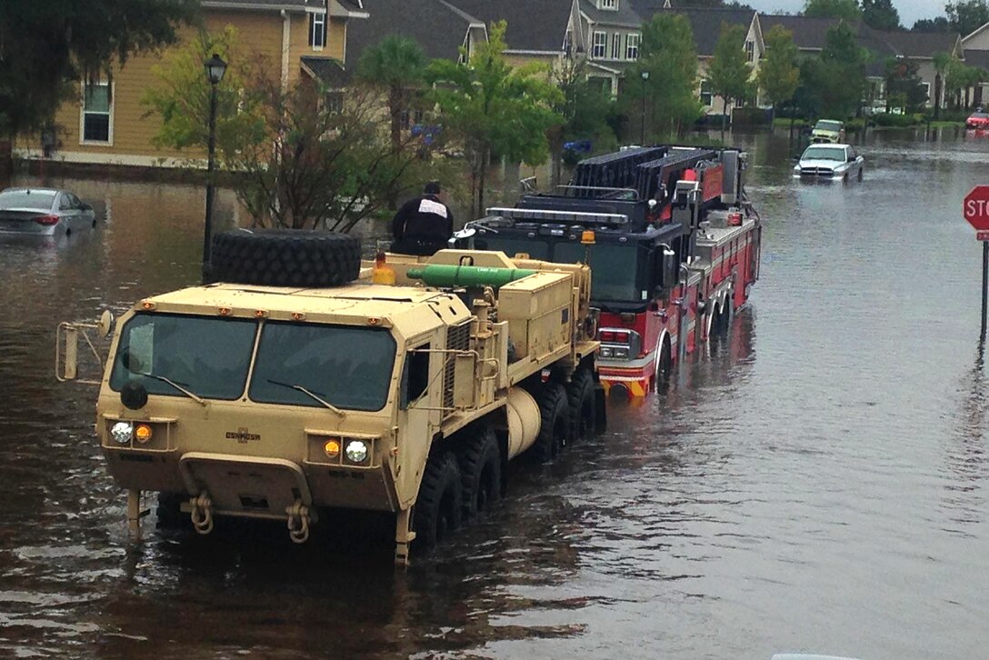 South Carolina Army National Guardsmen assigned to the 108th Chemical Company, and 1118th Forward Support Company, assist with a fire truck recovery in Charleston, S.C., Oct. 4, 2015. South Carolina Army National Guard photo by Capt. Brian Hare