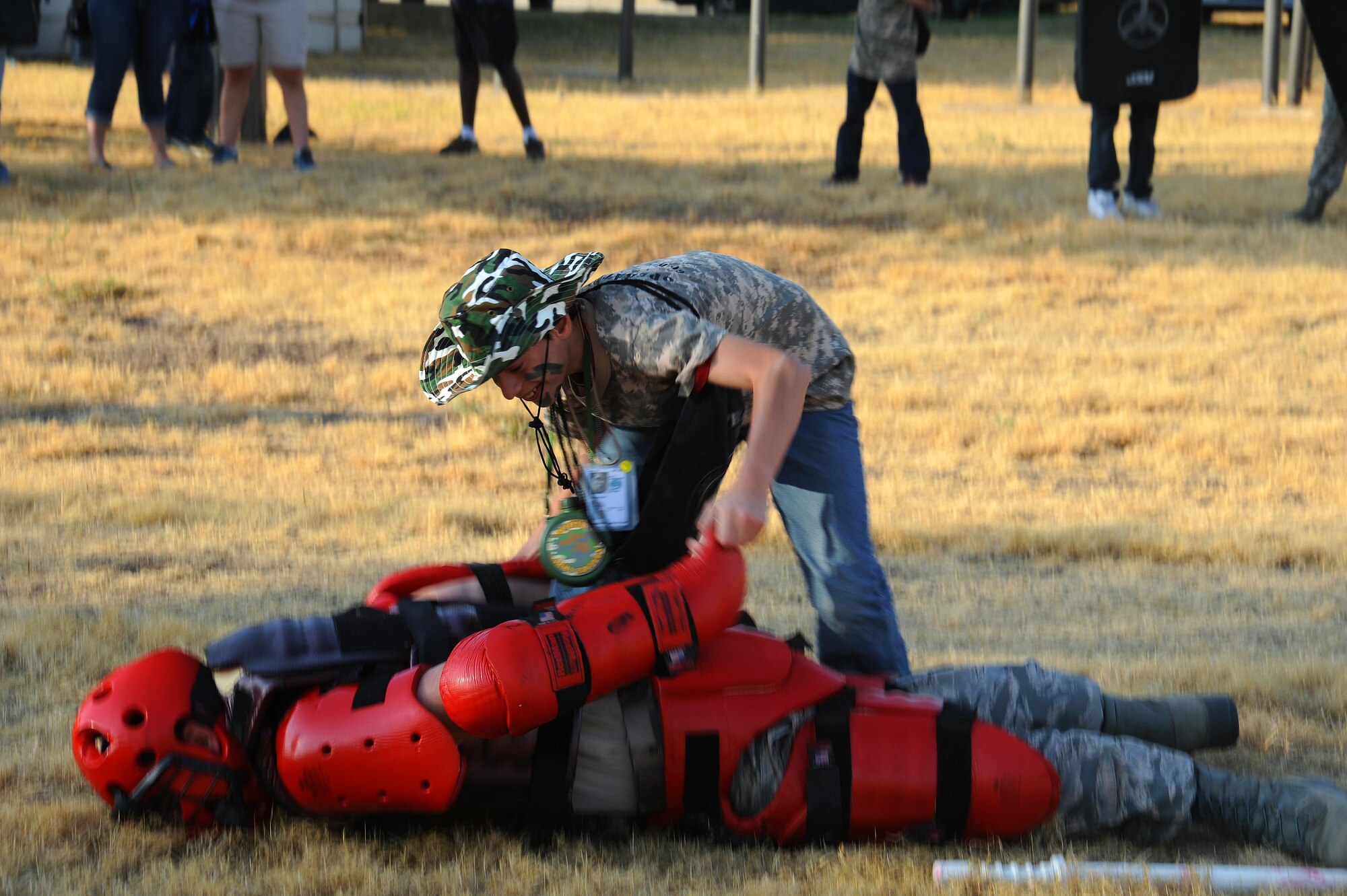 A dependent puts an Air Force Security Forces member on his face during Operation K.I.D.S at Goodfellow Air Force Base, Texas, Oct. 3, 2015. Operation K.I.D.S gave children the opportunity to learn basic combat training and deployment exercises. (U.S. Air Force photo by Airman Caelynn Ferguson/Released)

