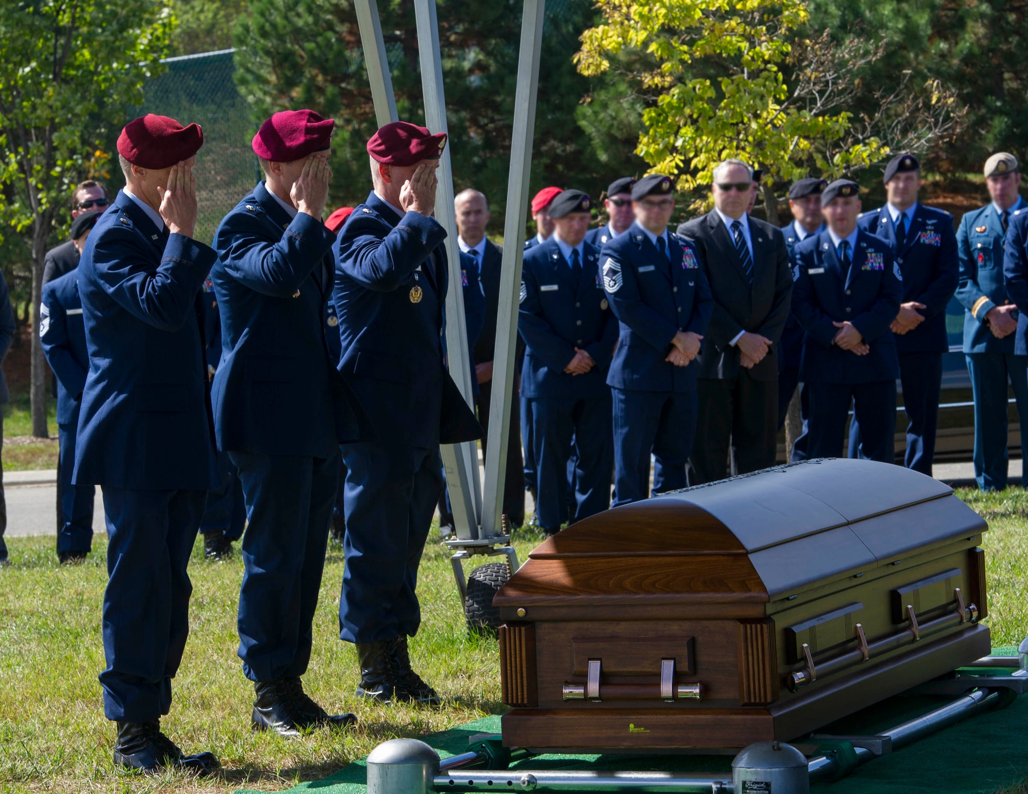 Three Special Tactics Air Commandos salute the casket of Tech. Sgt. Timothy Officer during his funeral at Arlington National Cemetery, Va, Oct. 5, 2015. (Photo by Senior Airman Dylan Nuckolls)