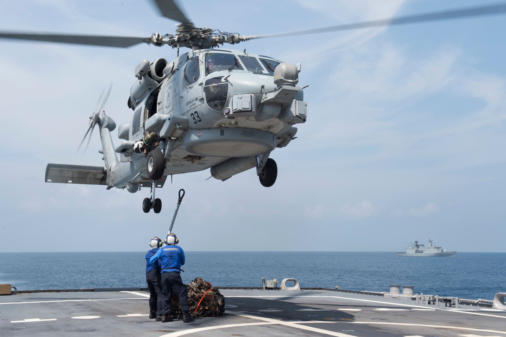 151001-N-MK881-655
BAY OF BENGAL (October 1, 2015) Sailors assigned to the littoral combat ship USS Fort Worth (LCS 3) attach a load during a vertical replenishment exercise as part Cooperation Afloat Readiness and Training (CARAT) Bangladesh 2015. CARAT is an annual, bilateral exercise series with the U.S. Navy, U.S. Marine Corps and the armed forces of nine partner nations. (U.S. Navy photo by Mass Communication Specialist 2nd Class Joe Bishop/Released)