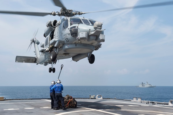 151001-N-MK881-655BAY OF BENGAL (October 1, 2015) Sailors assigned to the littoral combat ship USS Fort Worth (LCS 3) attach a load during a vertical replenishment exercise as part Cooperation Afloat Readiness and Training (CARAT) Bangladesh 2015. CARAT is an annual, bilateral exercise series with the U.S. Navy, U.S. Marine Corps and the armed forces of nine partner nations. (U.S. Navy photo by Mass Communication Specialist 2nd Class Joe Bishop/Released)