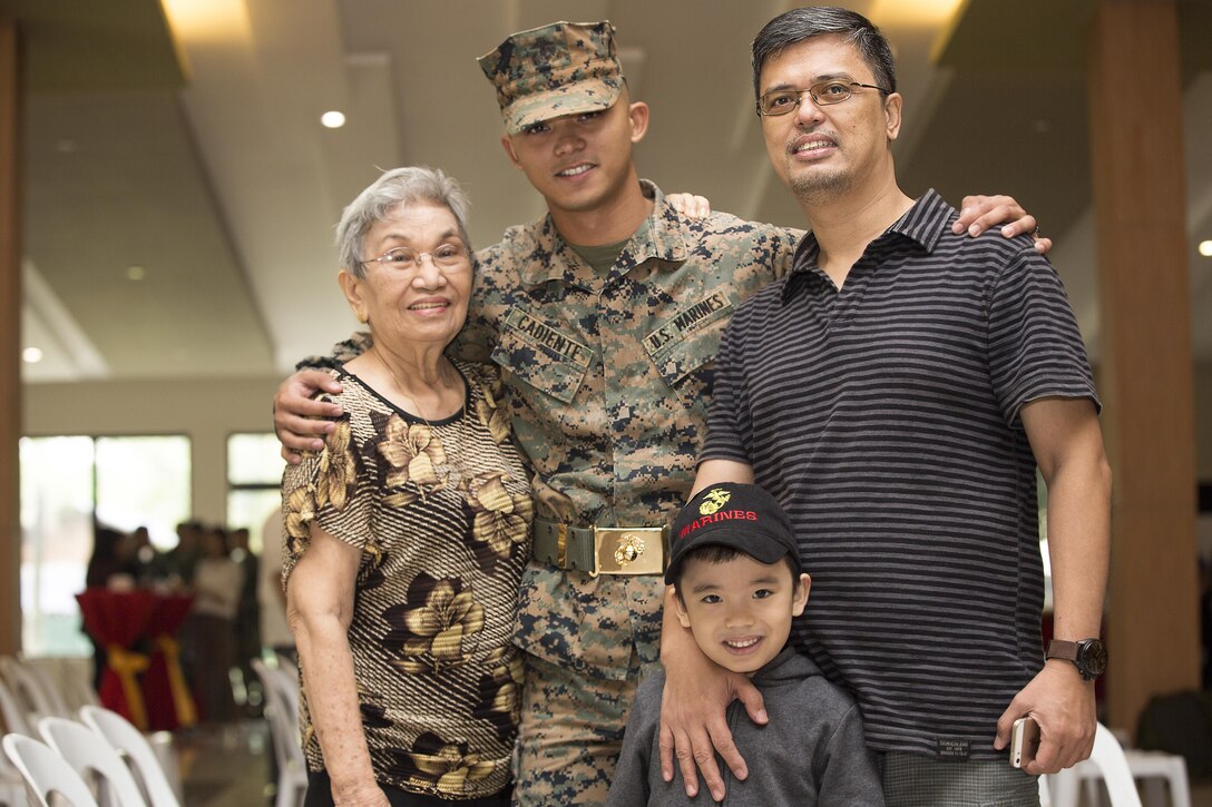 U.S. Marine Corps Sgt. Viktor I. Cadiente, a joint fires observer currently assigned to 3rd Marine Expeditionary Brigade, poses for a photo with his family during the opening ceremony for Amphibious Landing Exercise 2015 (PHIBLEX 15) at the Philippine Marine Corps Base in Fort Bonifacio, Taguig City, Philippines, Oct. 1, 2015. Cadiente, originally born and raised in the Philippines, is reunited with his grandmother, father, and brother after four years while serving the U.S. Marines. PHIBLEX 15 is an annual, bilateral training exercise conducted by U.S. Marine and Navy Forces with the Armed Forces of the Philippines in order to strengthen our interoperability and working relationships across the range of military operations from disaster relief, to complex expeditionary operations.