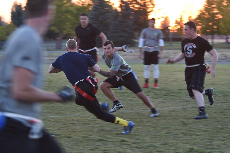 Senior Airman Joshua Winters, 92nd Security Forces Squadron installation entry controller, runs the ball in for a touchdown against Survival, Evasion, Resistance and Escape specialists during the intramural flag football championship game Sept. 30, 2015, at Fairchild Air Force Base, Wash. The 92nd SFS competed against the 92nd Civil Engineer Squadron, the 92nd Aircraft Maintenance Squadron and defeated Survival, Evasion, Resistance and Escape specialists in the championship game 35 to 21. (U.S. Air Force photo/Airman 1st Class Mackenzie Richardson)