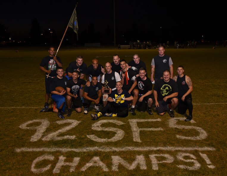 The 92nd Security Forces Squadron take the championship title for the second year running during the intramural flag football championship game Sept. 30, 2015, at Fairchild Air Force Base, Wash. The 92nd SFS clinched the playoff berth with eight wins and only two loses, tying with Survival, Evasion, Resistance and Escape specialists for the best record in the regular season standings. (U.S. Air Force photo/Airman 1st Class Mackenzie Richardson)