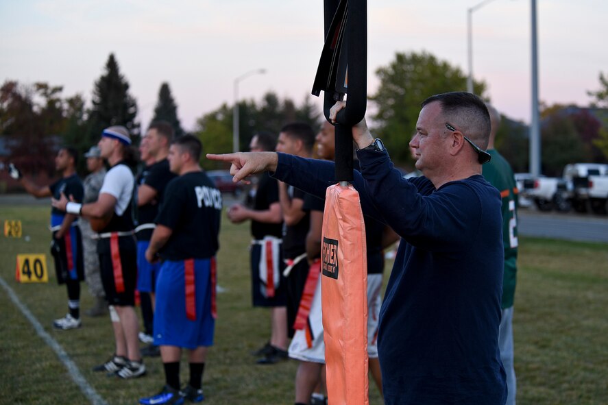 Col. Brian McDaniel, 92nd Air Refueling Wing commander, holds the down marker in the intramural flag football championship game between Survival, Evasion, Resistance and Escape specialists and the 92nd Security Forces Squadron Sept. 30, 2015, at Fairchild Air Force Base, Wash. The 92nd SFS clinched the championship title for the second year in a row with a final score of 35 to 21. (U.S. Air Force photo/Airman 1st Class Mackenzie Richardson)