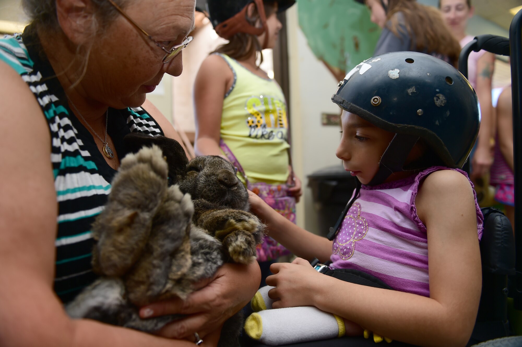 A child from Buckley Air Force Base pets a rabbit Sept. 26, 2015, at Urban Farm in Stapleton, Colo. Urban Farm hosted Buckley families, providing them with a tour of the farm as well as an opportunity to interact with the animals. (U.S. Air Force photo by Airman 1st Class Luke W. Nowakowski/Released)
