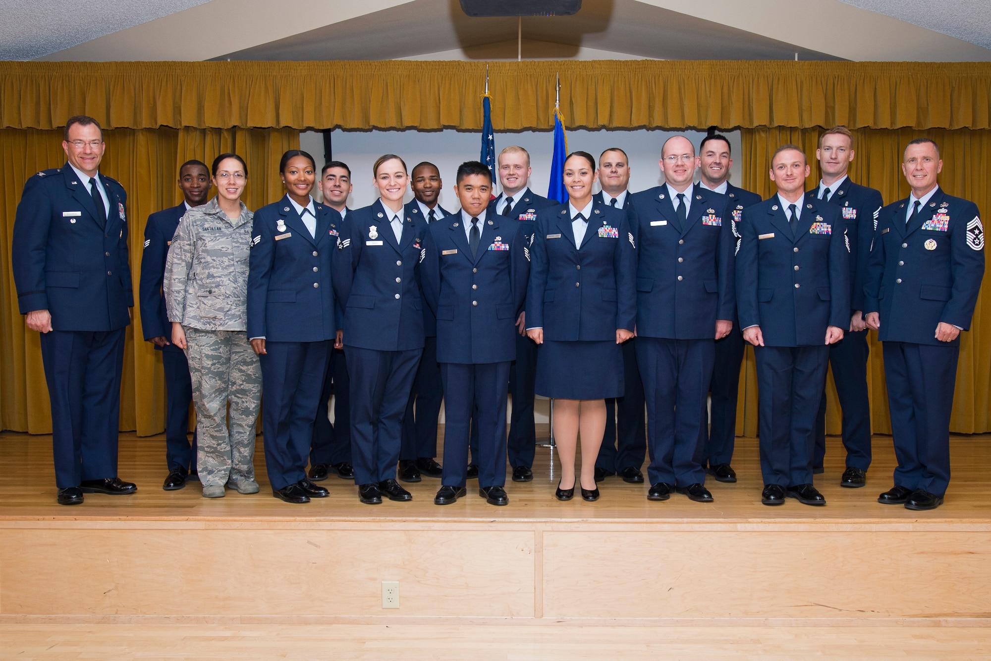 Some of Edwards AFB's newest enlisted promotees pose for a photo Sept. 30 in the base theater. The Airmen are joined by Col. David Radomski (left), 412th Test Wing vice commander, and Chief Master Sgt. David Smith, 412th Test Wing command chief, on the far right. (U.S. Air Force photo by Ethan Wagner)
