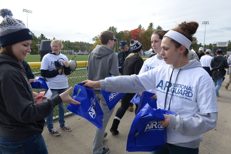Airman from the 157th Air Refueling Wing Student Flight hand out New Hampshire Air National Guard bags at the University of New Hampshire homecoming event at Boulder Field in Durham N.H., Oct 3, 2015. The members were there to promote the NHANG and get people interested in joining. (N.H. Air National Guard photo by Airman Ashlyn J. Correia/RELEASED)