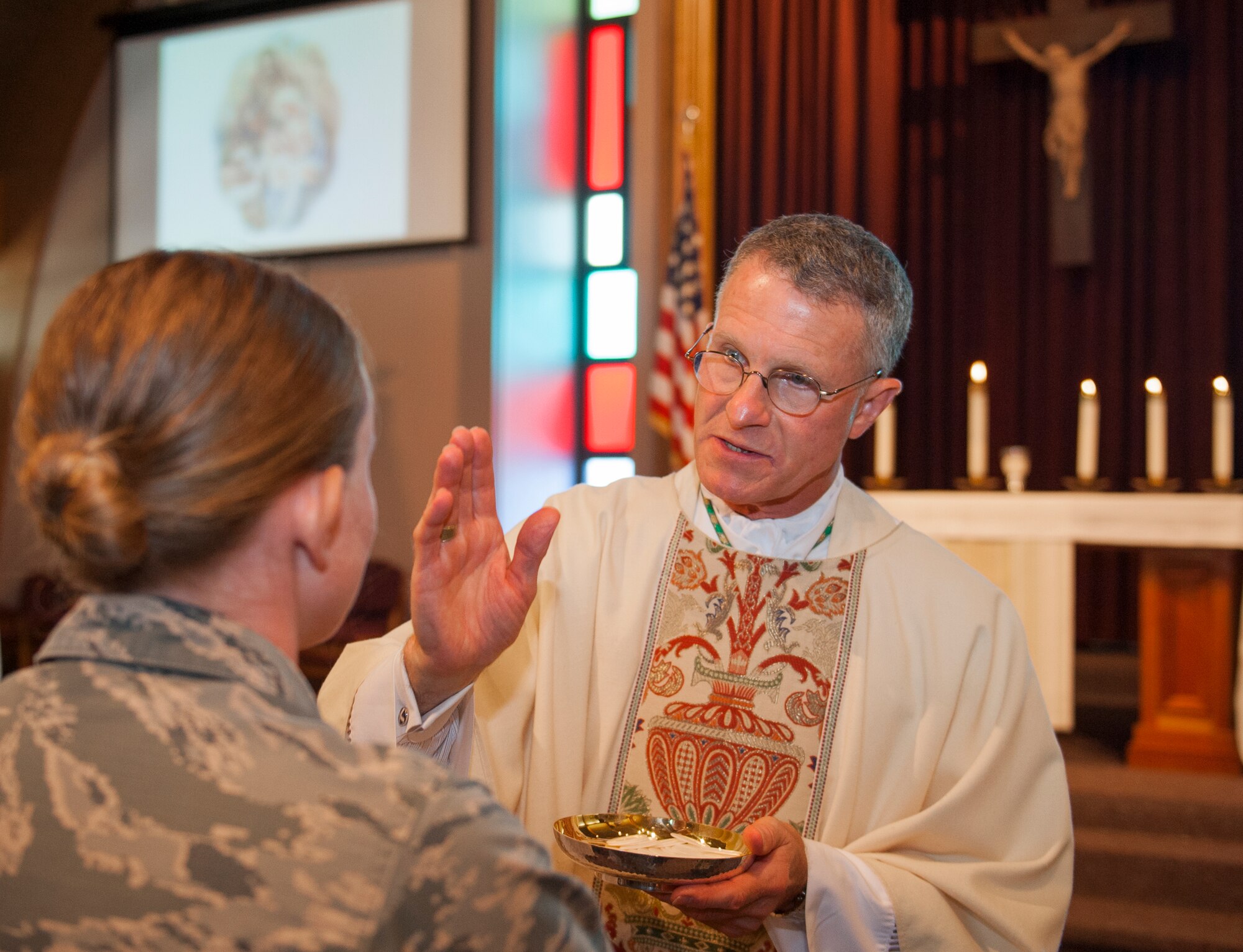 Archbishop of the Military Services, Timothy Broglio, blesses an Airman during a mass at the East Gate Chapel Sept. 30 at Eglin Air Force Base, Fla. Archbishop Broglio is the spiritual leader for the U.S. Armed Forces and visited Eglin as part of his pastoral duties. (U.S. Air Force photo/Ilka Cole) 