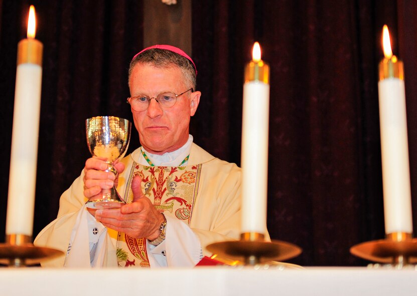 Archbishop of the Military Services, Timothy Broglio, raises the sacramental wine goblet during a mass at the East Gate Chapel Sept. 30 at Eglin Air Force Base, Fla. Archbishop Broglio is the spiritual leader for the U.S. Armed Forces and visited Eglin as part of his pastoral duties. (U.S. Air Force photo/Ilka Cole) 