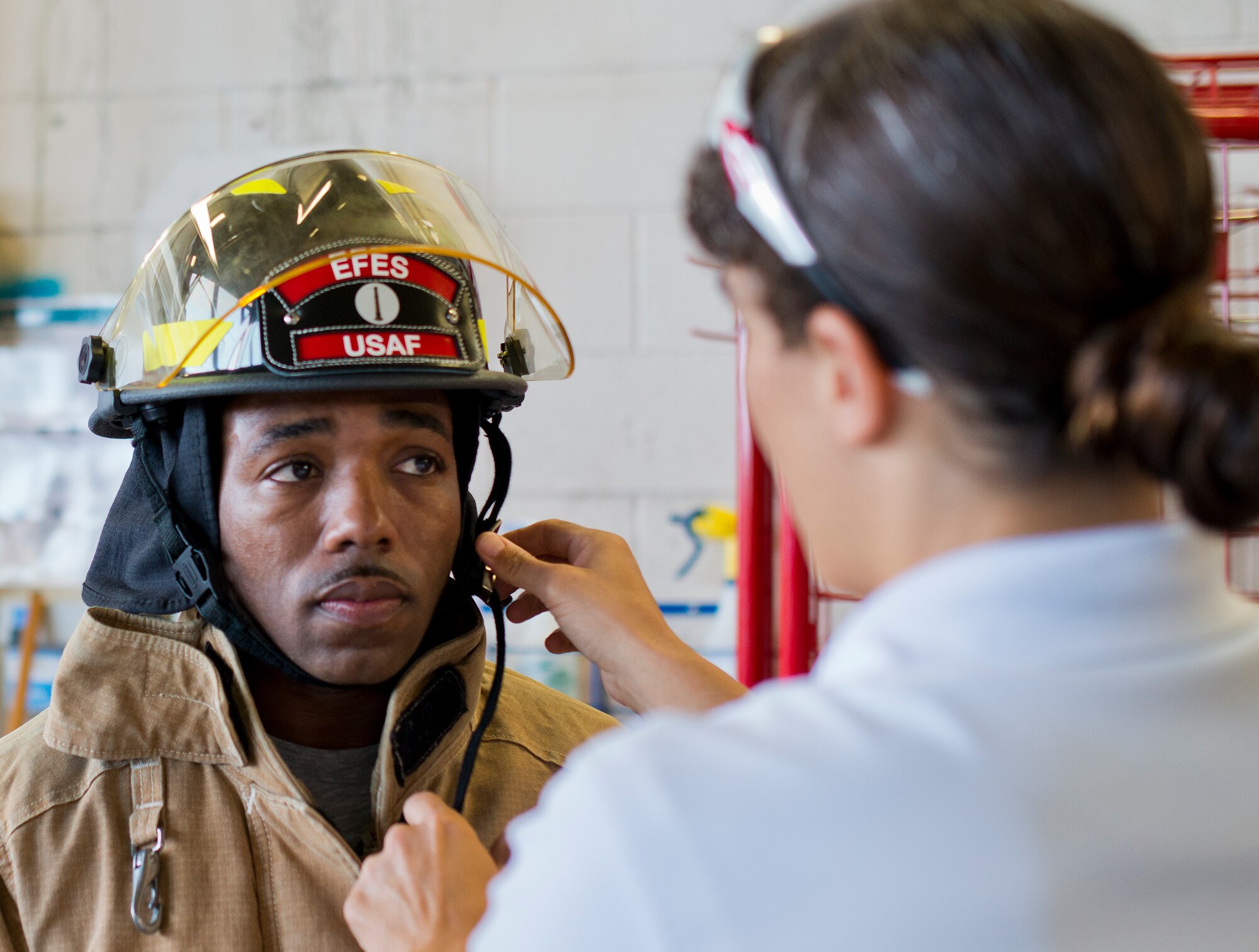 Chief Master Sgt. Samel Brown, 96th Security Forces Squadron, gets some last minute adjustments to his fire suit prior to the sixth annual Fire Prevention Week Readiness Challenge Oct. 5 at Eglin Air Force Base, Fla.  Commanders, chiefs and colonels participated in the challenge that replicated common fitness tasks of base firefighters.  The challenge included hose dragging, ladder climbing, victim carry among others.  (U.S. Air Force photo/Samuel King Jr.)  