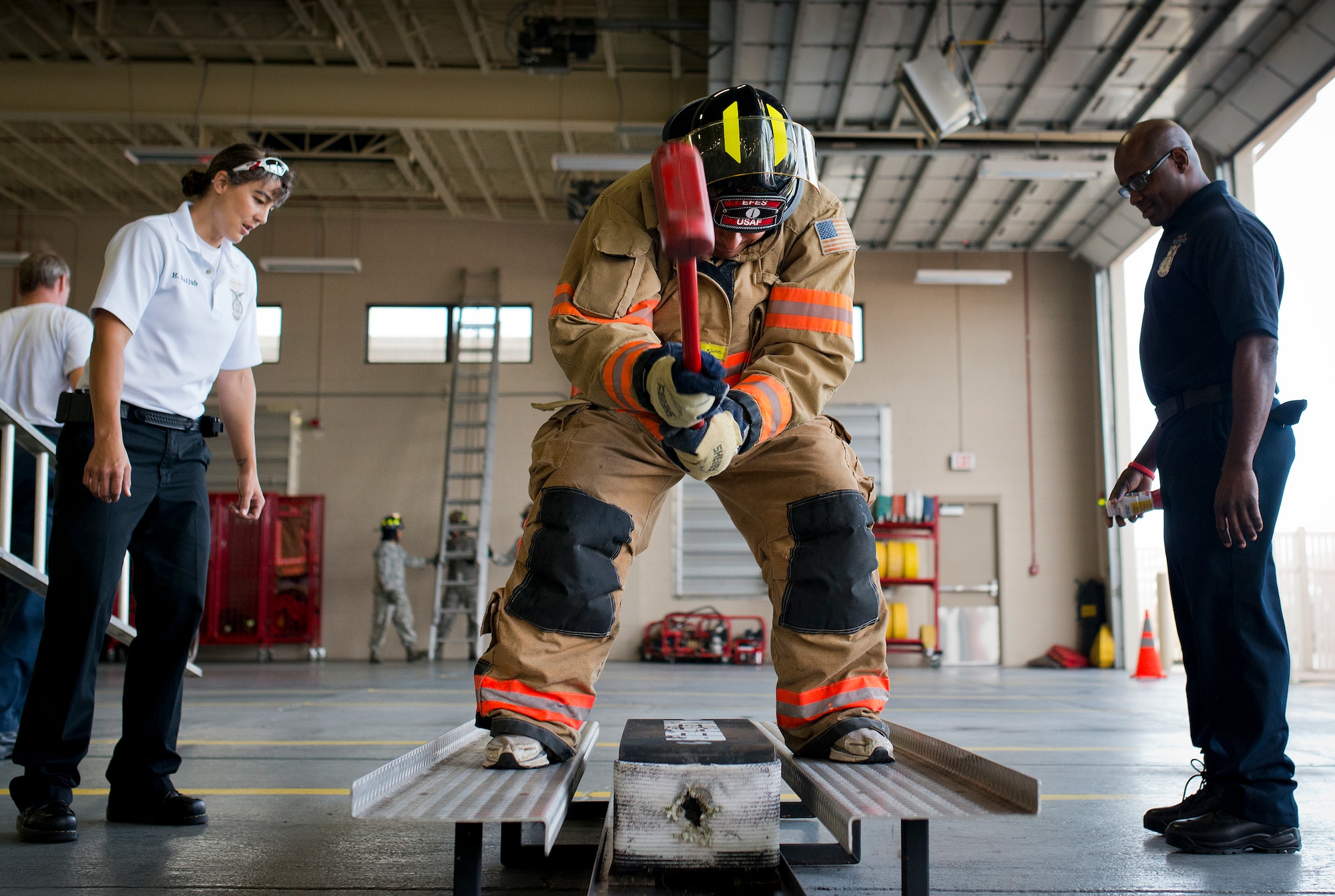 A participant brings a sledgehammer down through the sled during the sixth annual Fire Prevention Week Readiness Challenge Oct. 5 at Eglin Air Force Base, Fla.  Commanders, chiefs and colonels participated in the challenge that replicated common fitness tasks of base firefighters.  The challenge included hose dragging, ladder climbing, victim carry among others.  (U.S. Air Force photo/Samuel King Jr.)  