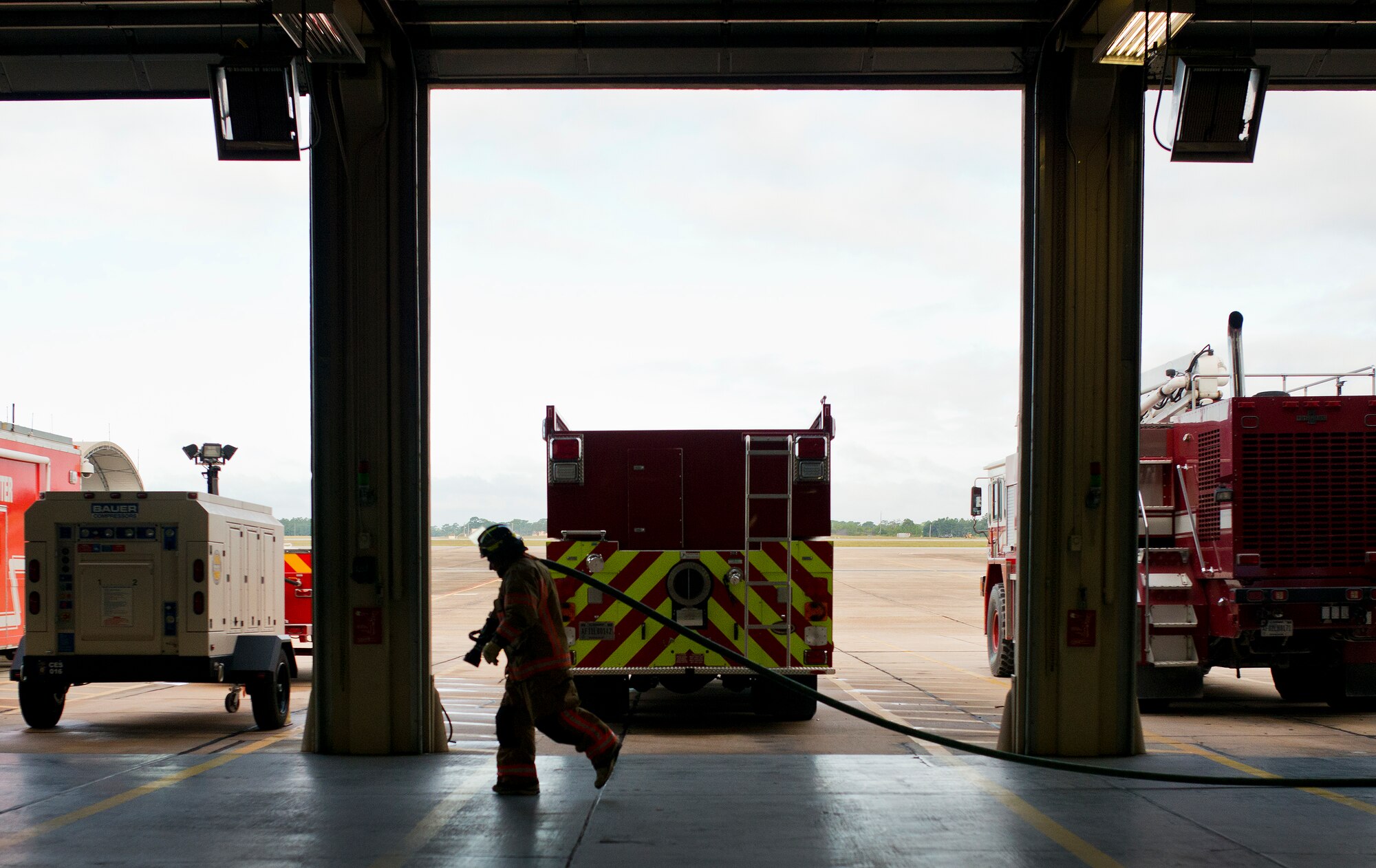 A participant carries a fire hose during the sixth annual Fire Prevention Week Readiness Challenge Oct. 5 at Eglin Air Force Base, Fla.  Commanders, chiefs and colonels participated in the challenge that replicated common fitness tasks of base firefighters.  The challenge included hose dragging, ladder climbing, victim carry among others.  (U.S. Air Force photo/Samuel King Jr.)  