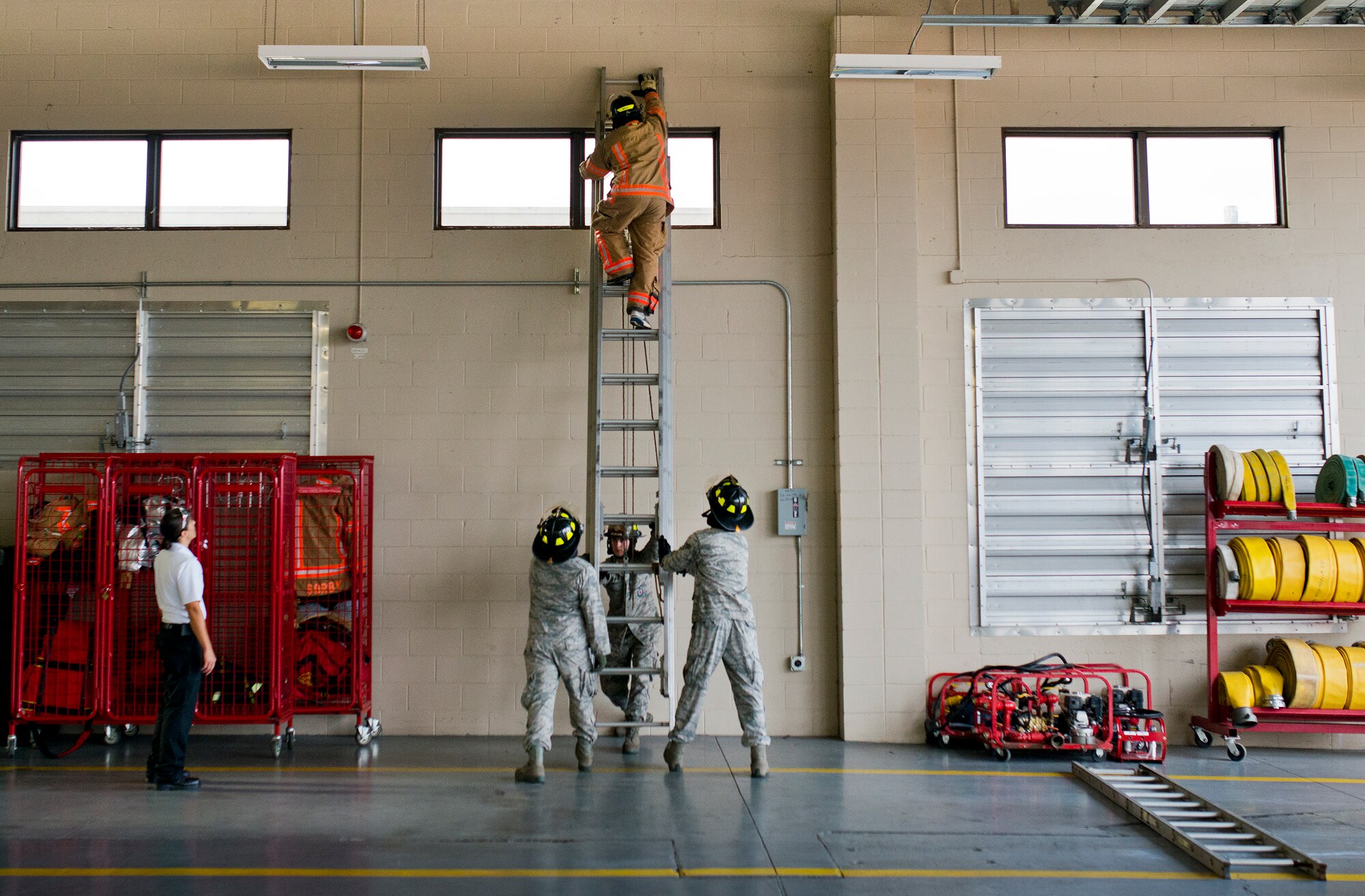 A participant reaches the top of the ladder during the sixth annual Fire Prevention Week Readiness Challenge Oct. 5 at Eglin Air Force Base, Fla.  Commanders, chiefs and colonels participated in the challenge that replicated common fitness tasks of base firefighters.  The challenge included hose dragging, ladder climbing, victim carry among others.  (U.S. Air Force photo/Samuel King Jr.)  