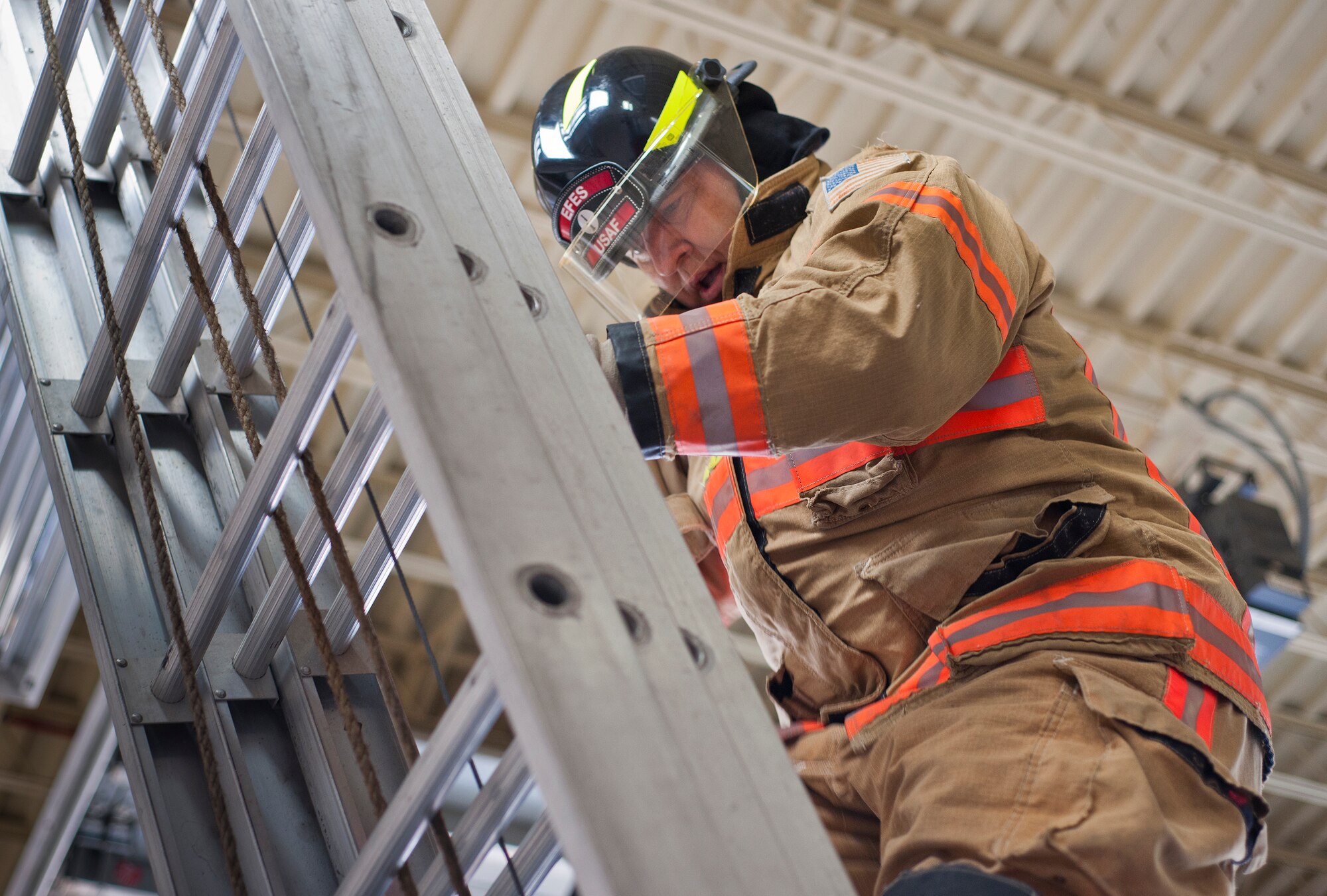 Col. Eric North, 96th Maintenance Group commander, climbs a ladder during the sixth annual Fire Prevention Week Readiness Challenge Oct. 5 at Eglin Air Force Base, Fla.  Commanders, chiefs and colonels participated in the challenge that replicated common fitness tasks of base firefighters.  The challenge included hose dragging, ladder climbing, victim carry among others.  (U.S. Air Force photo/Samuel King Jr.)  