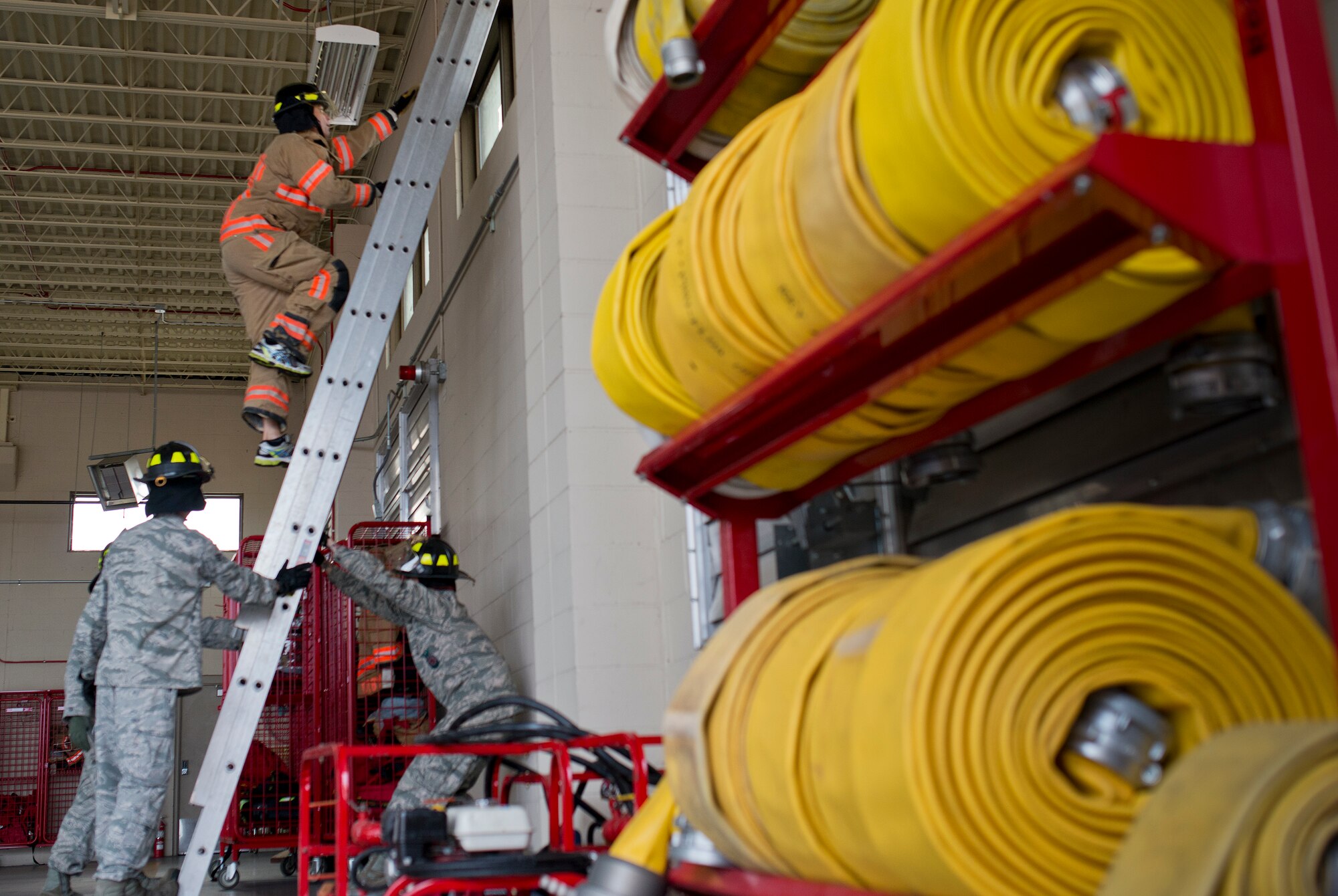 A participant climbs to the top of the ladder during the sixth annual Fire Prevention Week Readiness Challenge Oct. 5 at Eglin Air Force Base, Fla.  Commanders, chiefs and colonels participated in the challenge that replicated common fitness tasks of base firefighters.  The challenge included hose dragging, ladder climbing, victim carry among others.  (U.S. Air Force photo/Samuel King Jr.)  