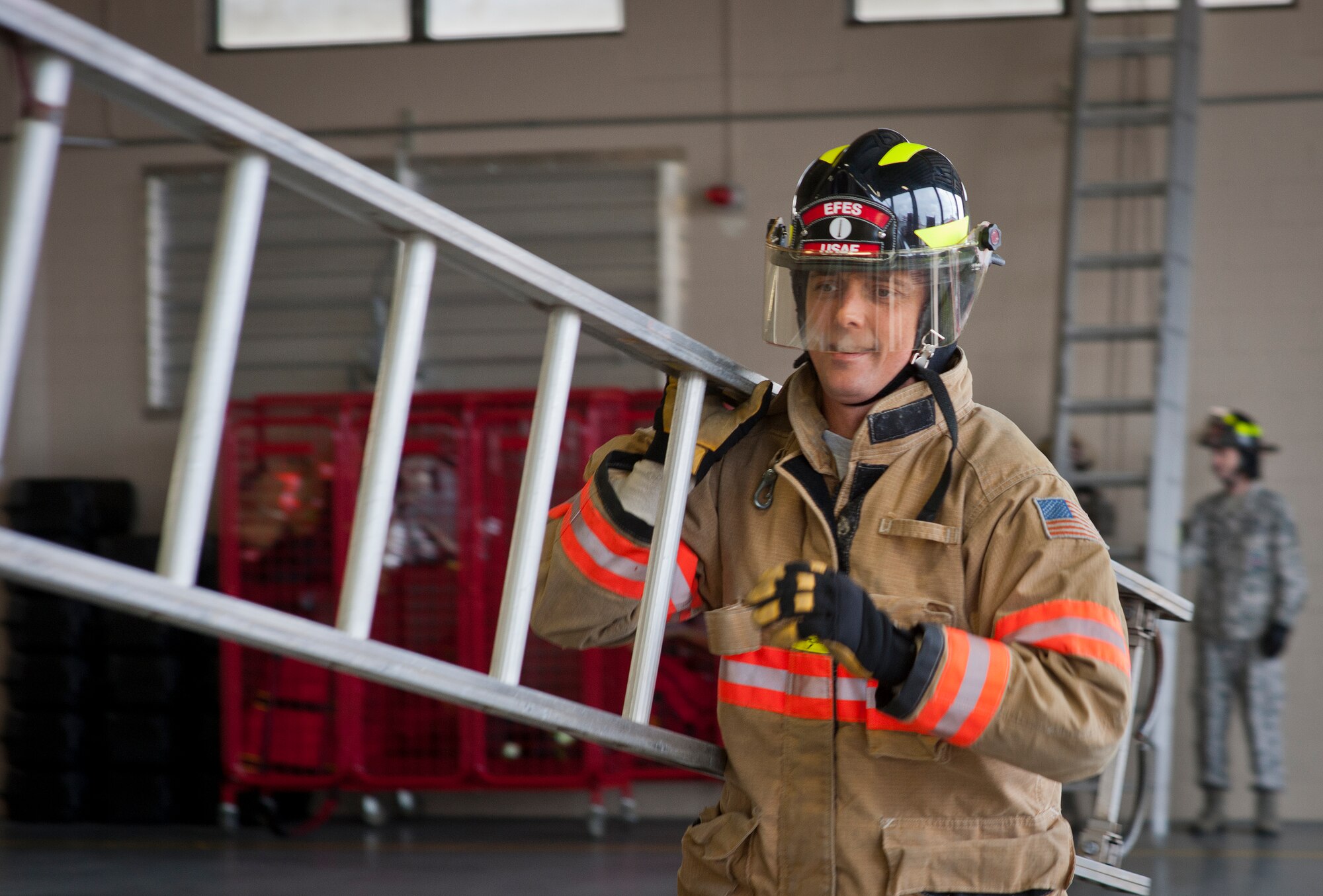 Maj. Paul Homan, 96th Weather Flight commander, carries a ladder during the sixth annual Fire Prevention Week Readiness Challenge Oct. 5 at Eglin Air Force Base, Fla.  Commanders, chiefs and colonels participated in the challenge that replicated common fitness tasks of base firefighters.  The challenge included hose dragging, ladder climbing, victim carry among others.  (U.S. Air Force photo/Samuel King Jr.)  