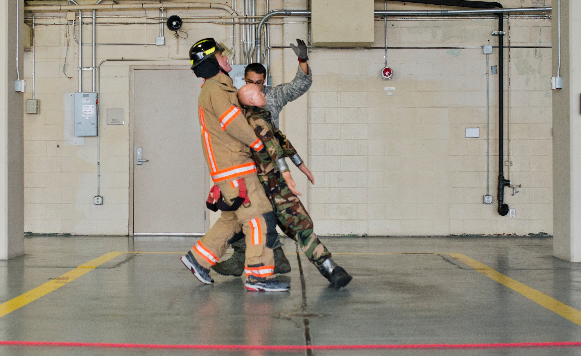 A participant carries a victim during the sixth annual Fire Prevention Week Readiness Challenge Oct. 5 at Eglin Air Force Base, Fla.  Commanders, chiefs and colonels participated in the challenge that replicated common fitness tasks of base firefighters.  The challenge included hose dragging, ladder climbing, victim carry among others.  (U.S. Air Force photo/Samuel King Jr.)  