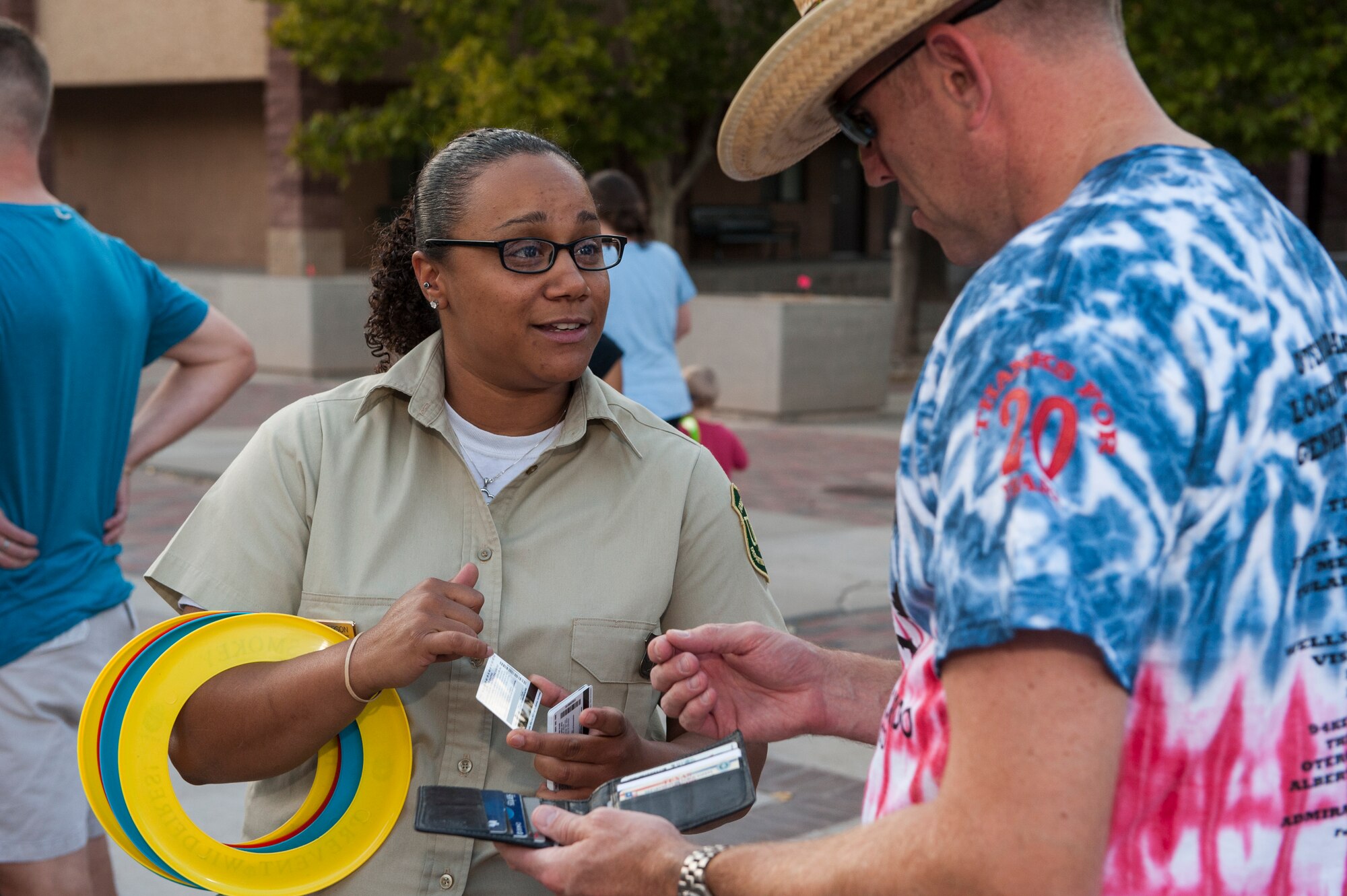 Leah Roberson, a Lincoln National Forest ranger, hands out free annual passes to members of Team Holloman at the annual Thanks Team Holloman event at Holloman Air Force Base, Oct. 2. Annual passes grant military members and their dependents free access to National Parks. Thanks Team Holloman gives the local community a chance to show appreciation for Holloman Air Force Base members through food, music and camaraderie. (U.S. Air Force photo by Airman 1st Class Randahl J. Jenson)