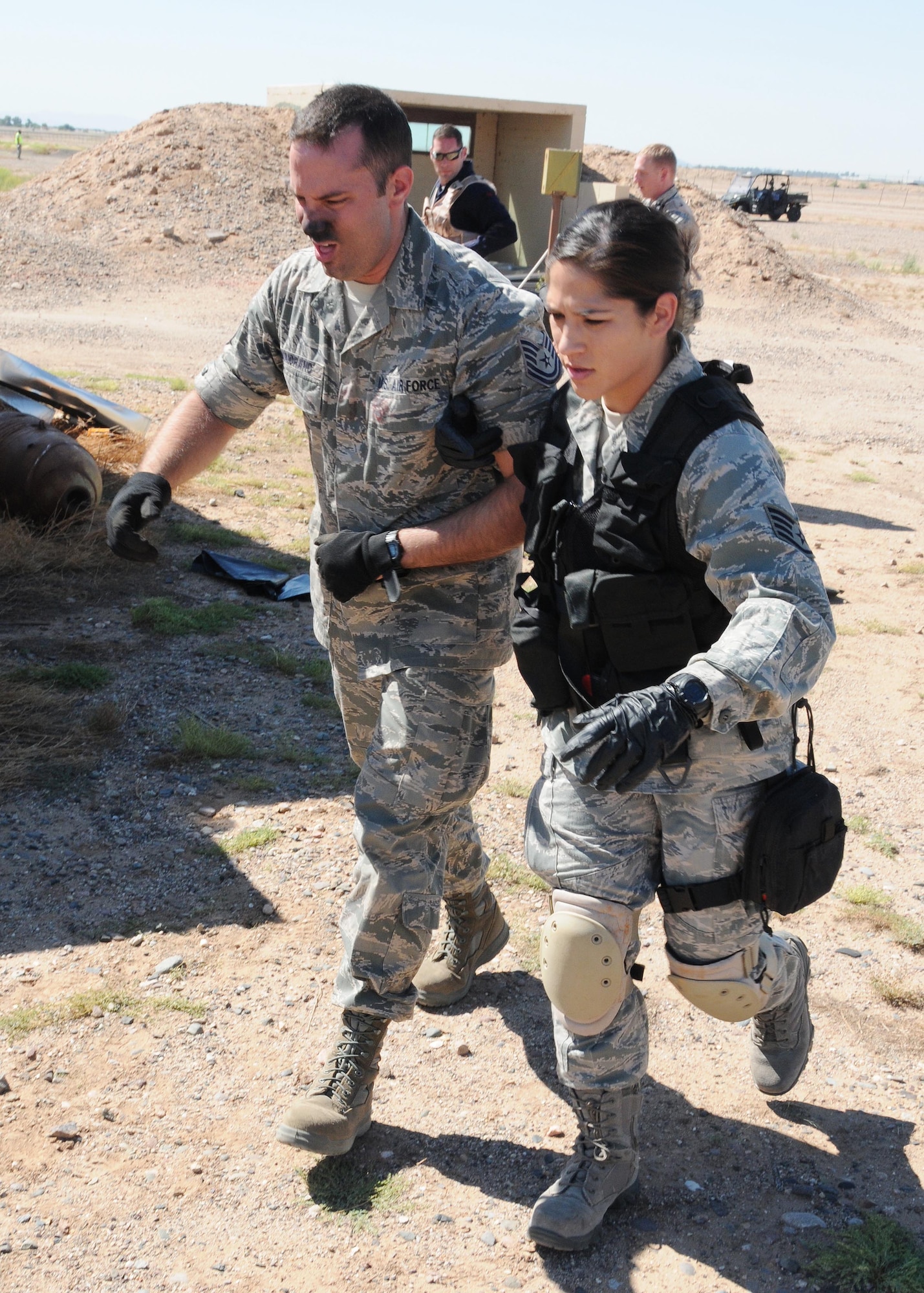 Staff Sgt. Renee Boehm and Tech. Sgt. Kevin Maiorano, 944th Aeromedical Staging Squadron aerospace medical services, participate in the field exercise portion of the Tactical Combat Casualty Care Course at Luke Air Force Base, Ariz., September 25,2015. (U.S. Air Force photo taken by Staff Sgt. Josh Nason)