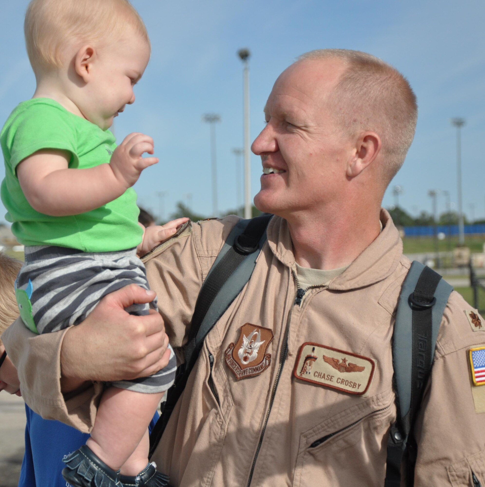 Maj. Chase Crosby, 18th Air Refueling Squadron pilot, greets his family after returning from a deployment to Southwest Asia, Oct. 4, 2014, at McConnell Air Force Base, Kan. Crosby returned along with 19 other members of the 931st Air Refueling Group.(U.S. Air Force photo by Tech. Sgt. Abigail Klein)