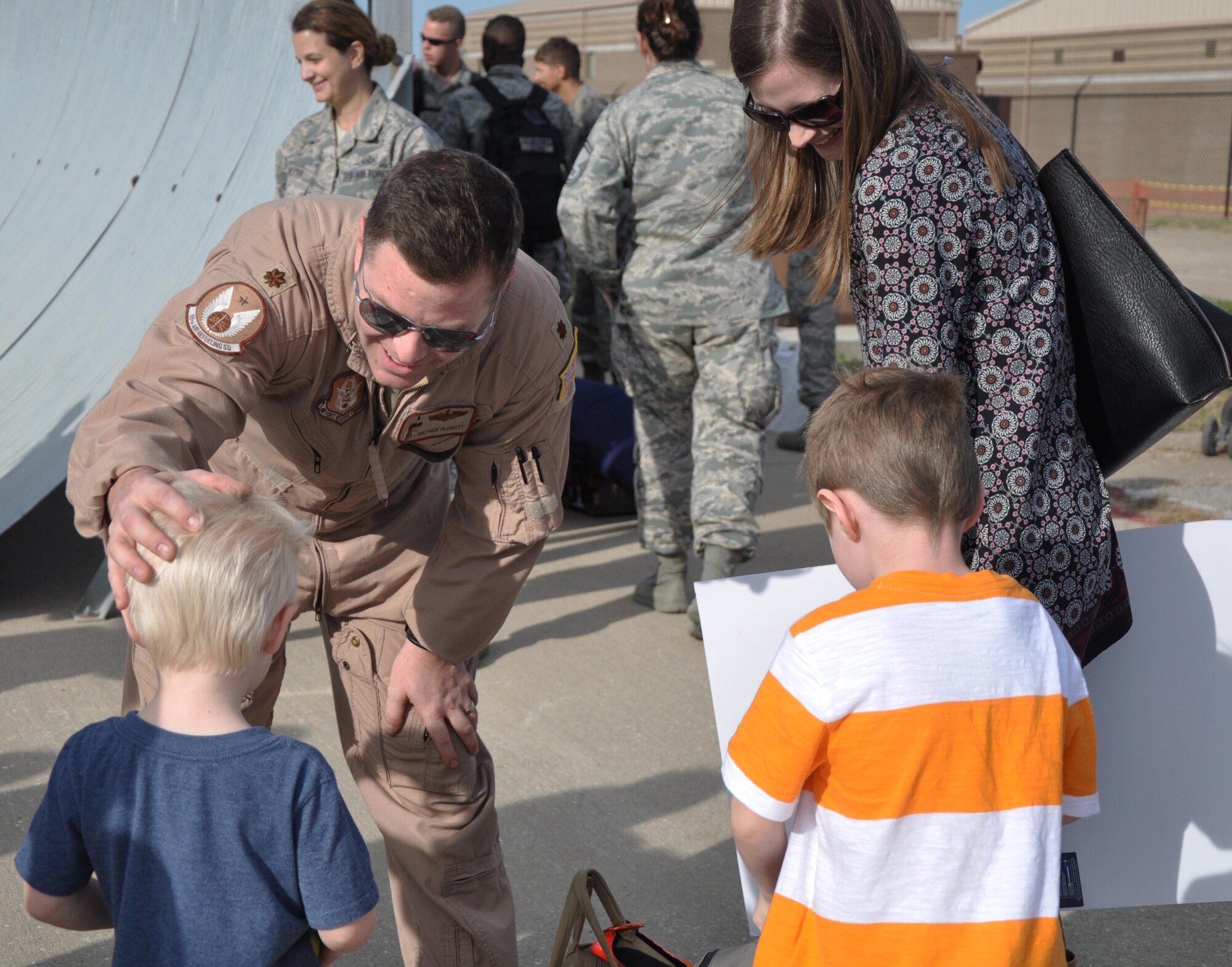 Maj. Matthew Plunkett, 18th Air Refueling Squadron pilot, greets his family after returning from a deployment to Southwest Asia, Oct. 4, 2015, at McConnell Air Force Base, Kan. Plunkett and 19 other Reservists deployed as part of ongoing U.S. operations overseas. (U.S. Air Force photo by Tech. Sgt. Abigail Klein)