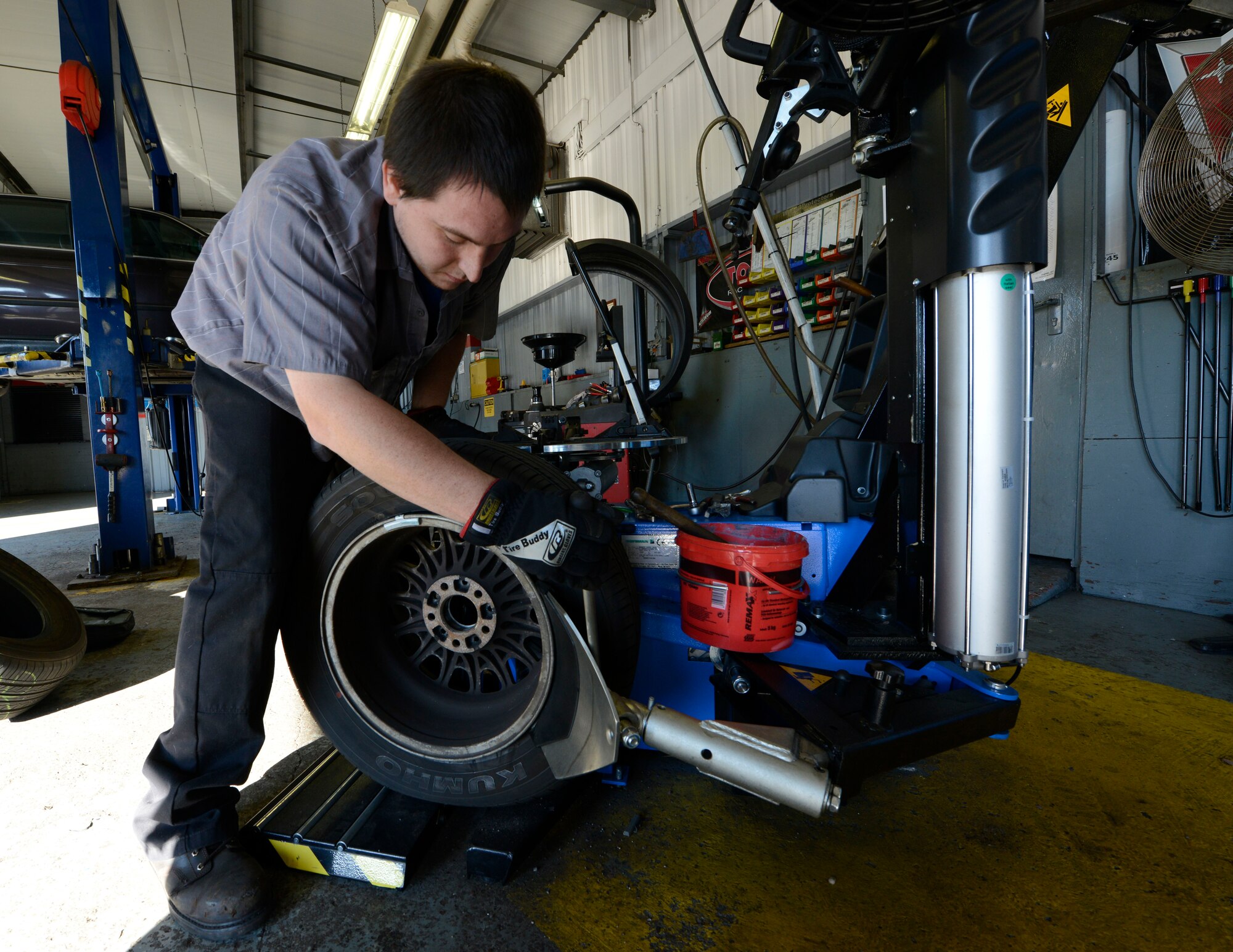 Ryan Dyle, Ramstein Auto Skills Center mobile equipment servicer, changes a summer tire for a winter tire Oct. 1, 2015, at Ramstein Air Base, Germany. The auto center provides services to put winter tires on a vehicle or the space and equipment if one wished to change their tires themselves. (U.S. Air Force photo/Airman 1st Class Tryphena Mayhugh)