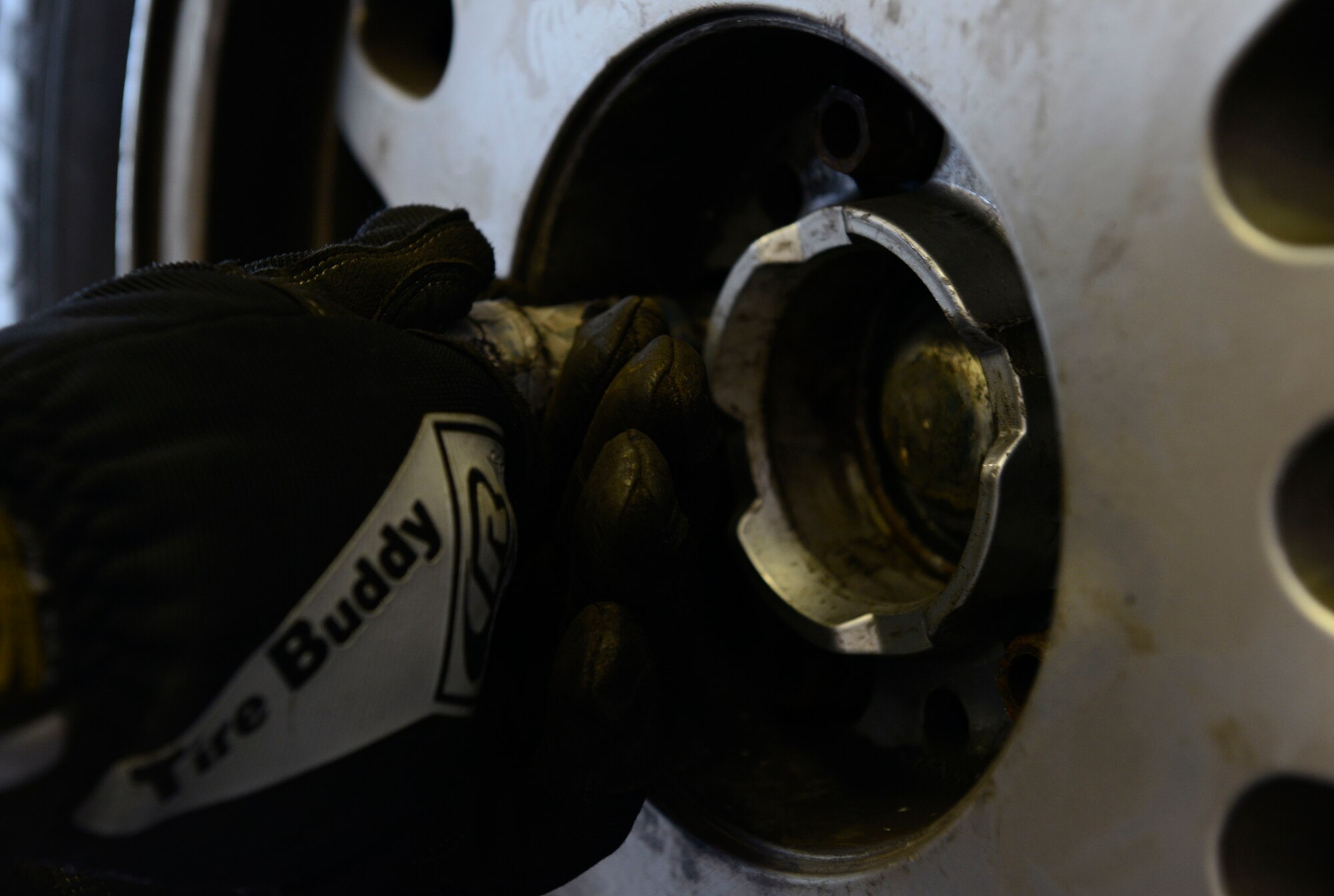 Ryan Dyle, Ramstein Auto Skills Center mobile equipment servicer, tightens bolts to secure a winter tire to an automobile Oct. 1, 2015, at Ramstein Air Base, Germany. Patrons of the auto center can have their tires changed by staff members or use the facilities to switch them over themselves. (U.S. Air Force photo/Airman 1st Class Tryphena Mayhugh)