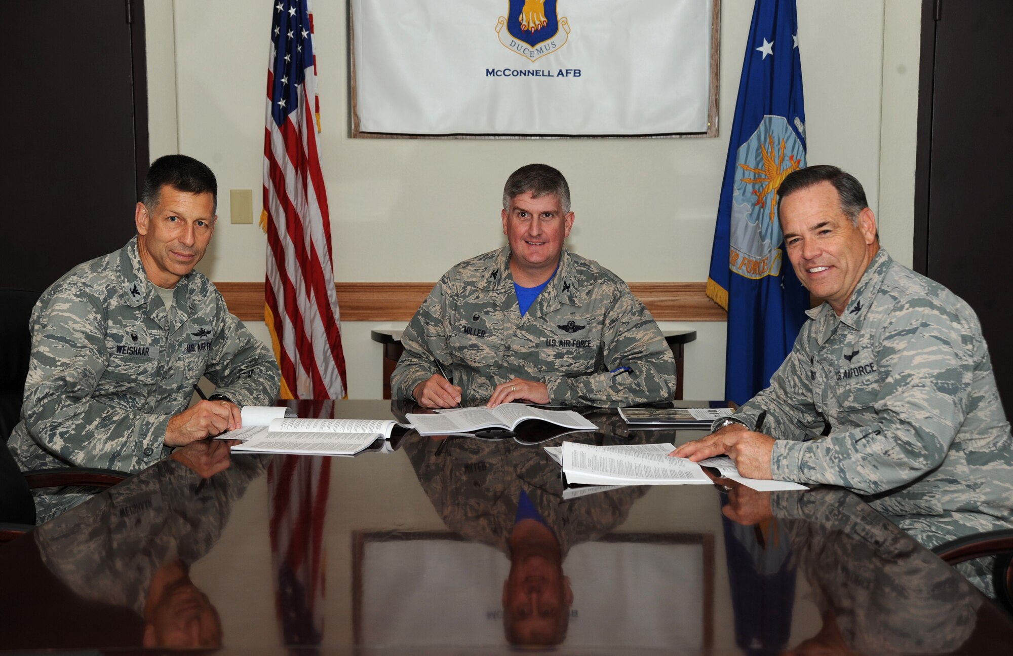 Col. David Weishaar, left, 184th Mission Support Group commander, Col. Albert Miller, 22nd Air Refueling Wing commander, and Col. Mark S. Larson, 931st Air Refueling Group commander, pose for a photo as they fill out their donation forms for the Combined Federal Campaign, Oct. 2, 2015, at McConnell Air Force Base, Kan. The CFC works on behalf of over 2,000 charitable organizations to raise money for health and human welfare causes. (U.S. Air Force photo by Jenna K. Caldwell)