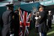 U.S. Service members with the RAF Molesworth Honor Guard assist members of the U.K. Color Guard with uncasing the Union Flag before the start of the International Series, Miami Dolphins versus New York Jets NFL game at Wembly Stadium, London October 4, 2015. Military personnel from the United Kingdom and the United States joined together for the performance of the national anthems of both countries during the NFL games in London. (U.S. Air Force photo by Staff Sgt. Ashley Hawkins/Released)