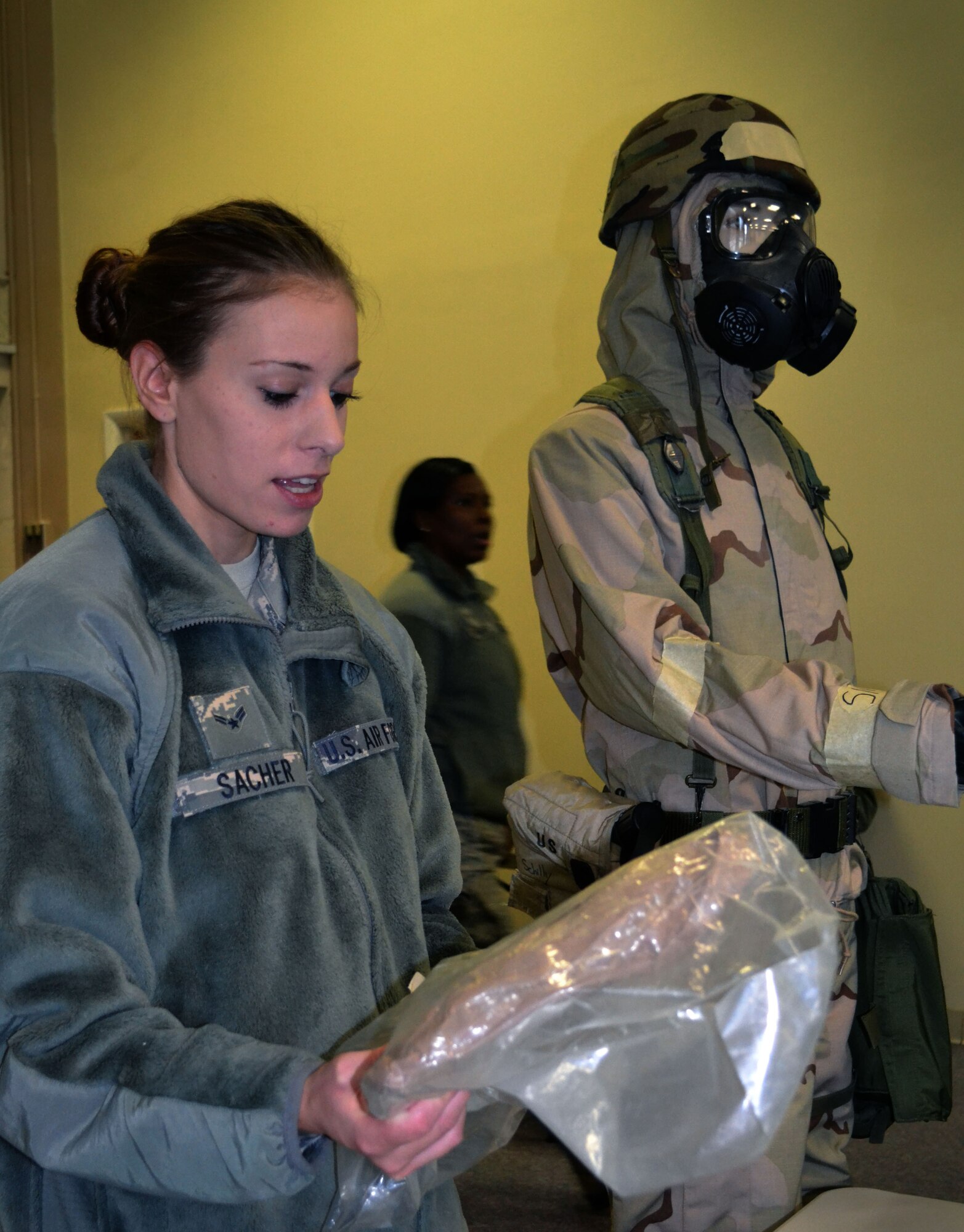 Airman 1st Class Anna Sachar explains personal decontamination during Chemical, Biological, Radiological, Nuclear and Explosives survival training Oct. 3, 2015, at Horsham Air Guard Station, Pennsylvania. Sachar showed participants from the 111th Attack Wing how to use the M-295 mitt. (U.S. Air Force photo by Tech. Sgt. Andria Allmond/Released)