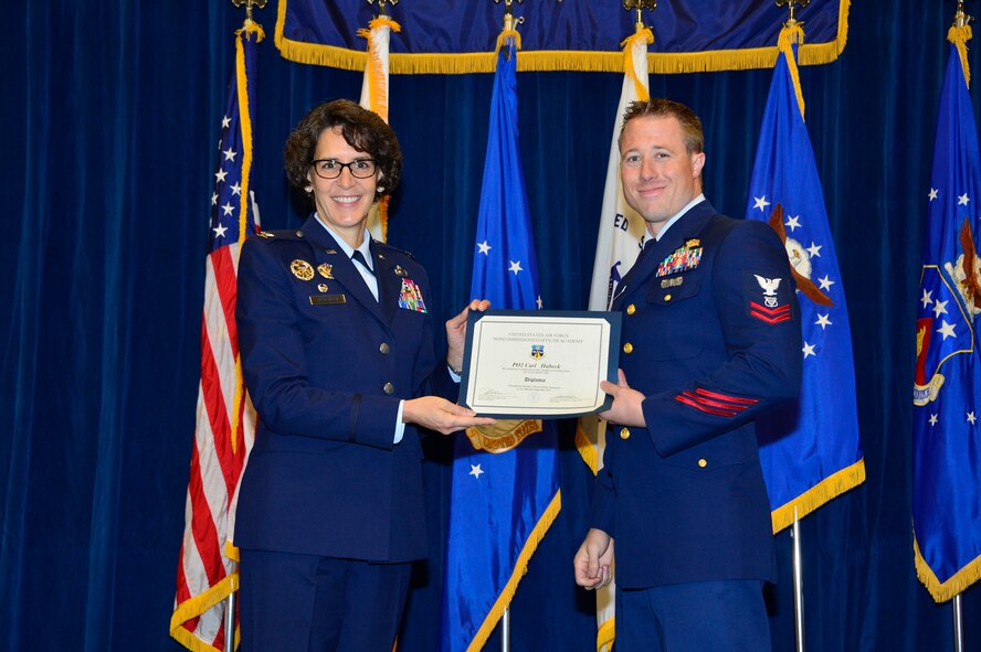 MCGHEE TYSON AIR NATIONAL GUARD BASE, Tenn. - Petty Officer 2nd Class Carl Habeck, receives his diploma from NCO academy Class 15-6 from Col. Jessica Meyeraan, commander of the I.G. Brown Training and Education Center, here, Sept. 30, 2015, at the TEC. The TEC often hosts students from the Coast Guard at the Airman leadership School and NCO academy. (U.S. Air National Guard photo by Master Sgt. Jerry D. Harlan/Released)