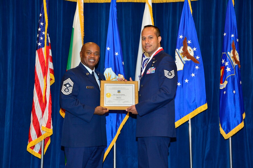 MCGHEE TYSON AIR NATIONAL GUARD BASE, Tenn. - Tech. Sgt. John Walling, right, receives the Distinguished Graduate Award for NCO academy class 15-6 from  Chief Master Sgt. Anthony Whitehead, command Chief Master Sgt. for the Air National Guard Readiness Center, here, Sept. 30, 2015, at the I. G. Brown Training and Education Center. The distinguished graduate award is presented to students in the top 10 percent of the class. (U.S. Air National Guard photo by Master Sgt. Jerry D. Harlan/Released)
