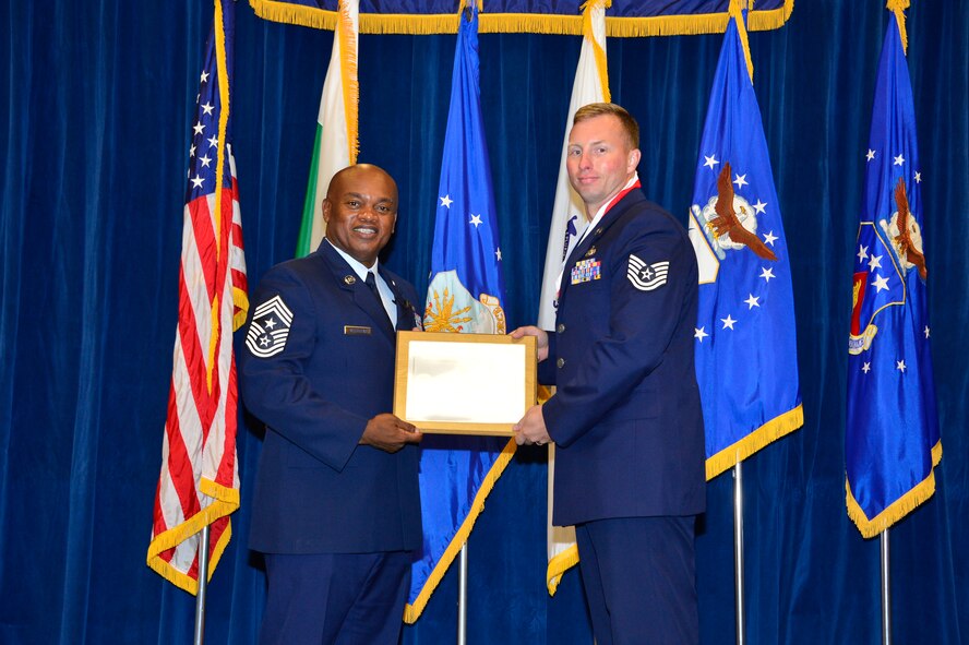 MCGHEE TYSON AIR NATIONAL GUARD BASE, Tenn. - Tech. Sgt. Colin Carr, right, receives the Distinguished Graduate Award for NCO academy class 15-6 from  Chief Master Sgt. Anthony Whitehead, command Chief Master Sgt. for the Air National Guard Readiness Center, here, Sept. 30, 2015, at the I. G. Brown Training and Education Center. The distinguished graduate award is presented to students in the top 10 percent of the class. (U.S. Air National Guard photo by Master Sgt. Jerry D. Harlan/Released)