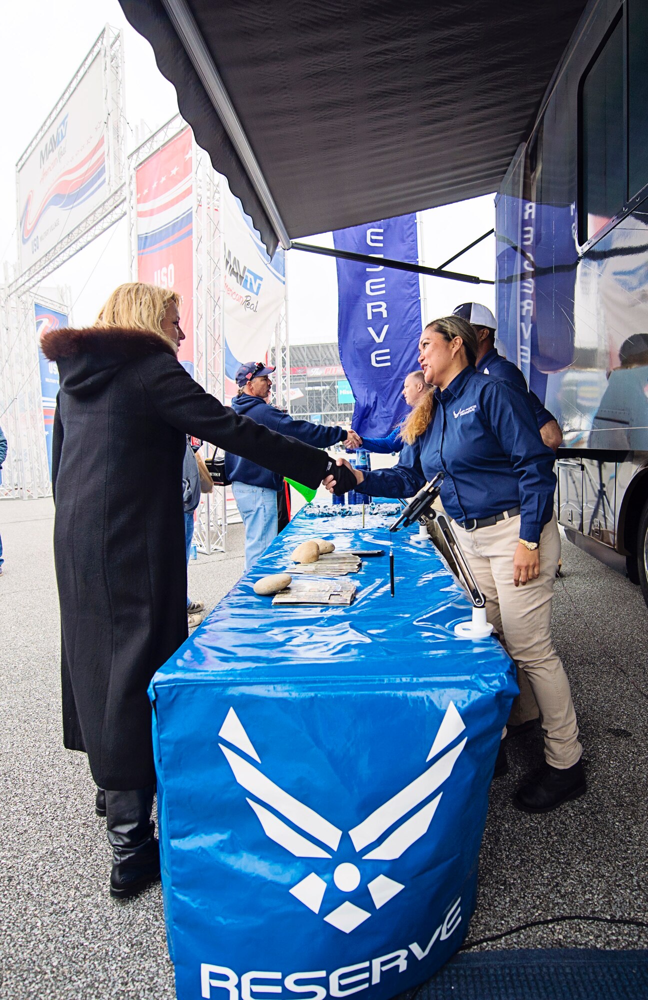 Air Force Reserve recruiters from the 512th Airlift Wing, Dover Air Force Base, Del., meet Secretary of the Air Force Deborah Lee James while they manned a booth and an AF Reserve recreational vehicle inside the Military Village Expo at the AAA 400 NASCAR race at the Dover International Speedway, Dover, Del., Oct. 4. James was an honored guest at the track and administered the oath of enlistment to over 22 recruits entering the Armed Services, along with meeting members of ‪Team Dover‬. (U.S. Air Force photo/Capt. Bernie Kale)
